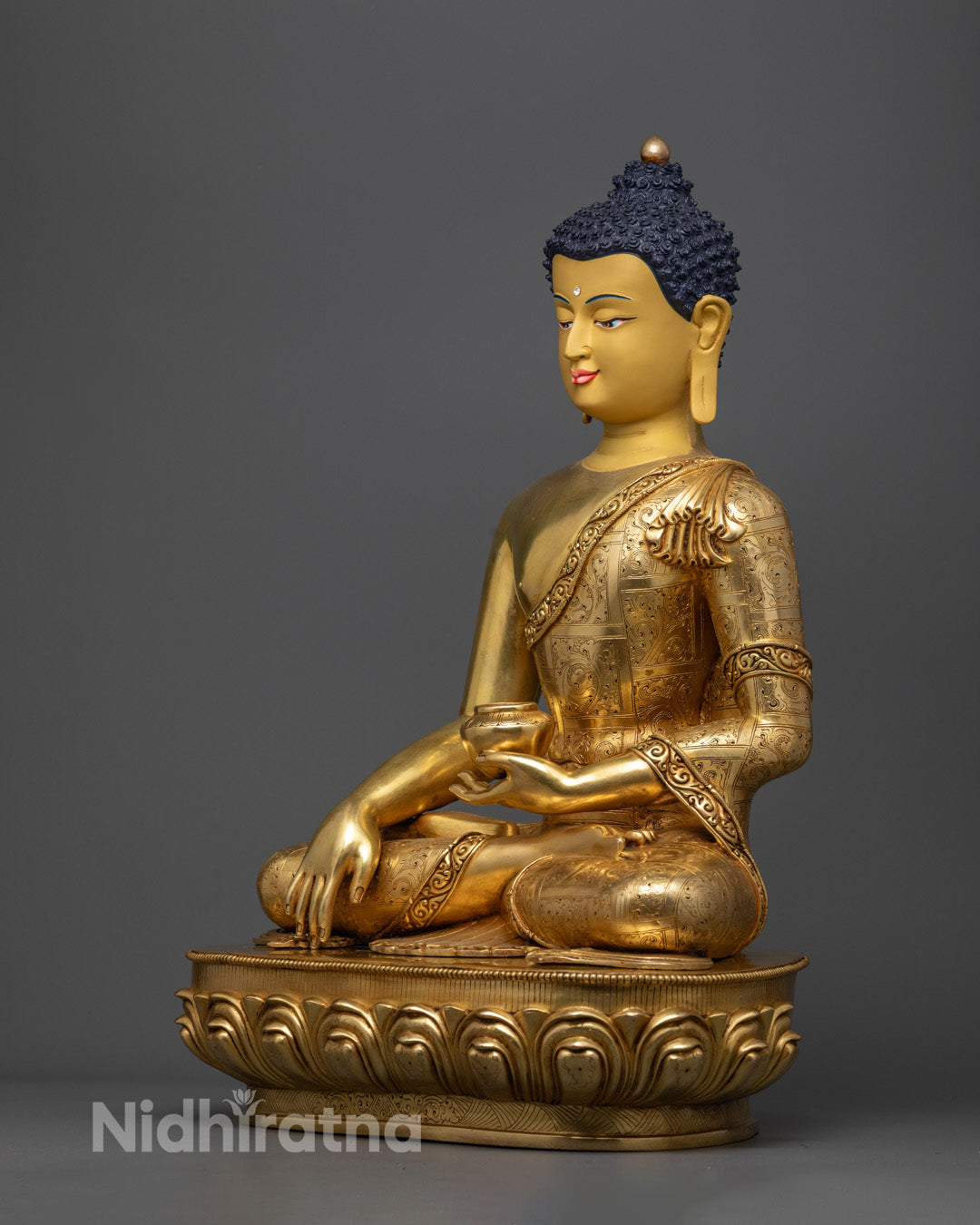 Shakyamuni Buddha holding a patra (alms bowl) symbolizing detachment and spiritual discipline.