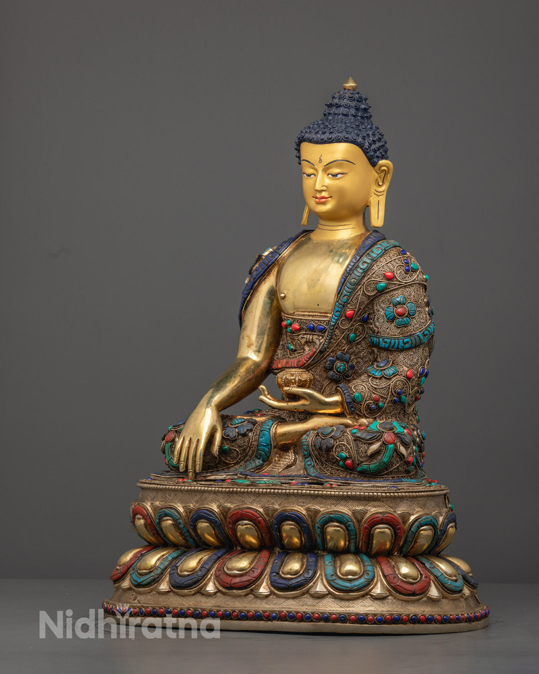 Shakyamuni Buddha’s lotus throne inlaid with semi-precious stones, showcasing masterful lost wax craftsmanship