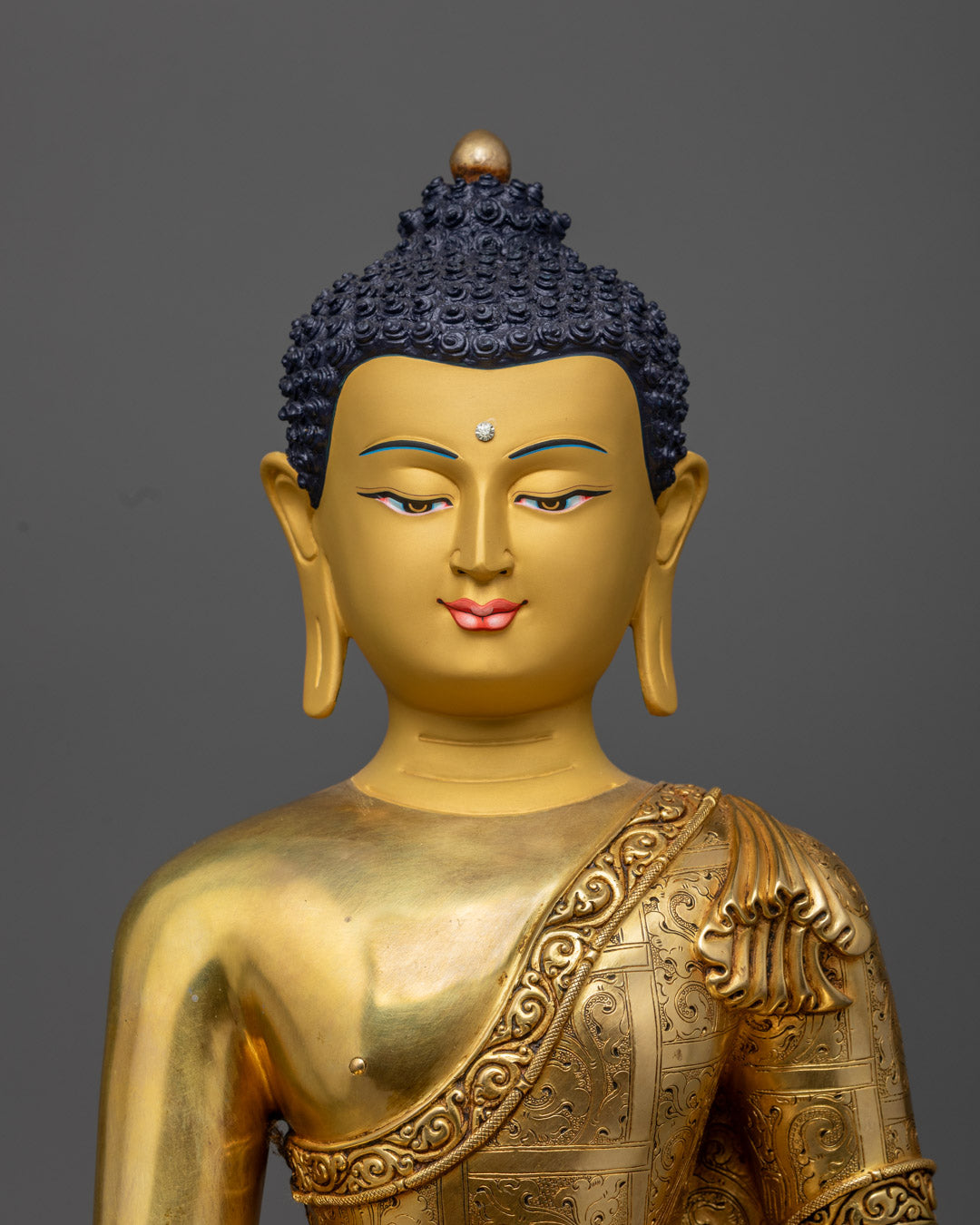 Shakyamuni Buddha’s serene 24K gold-gilded face, made using traditional fire-gilding technique.