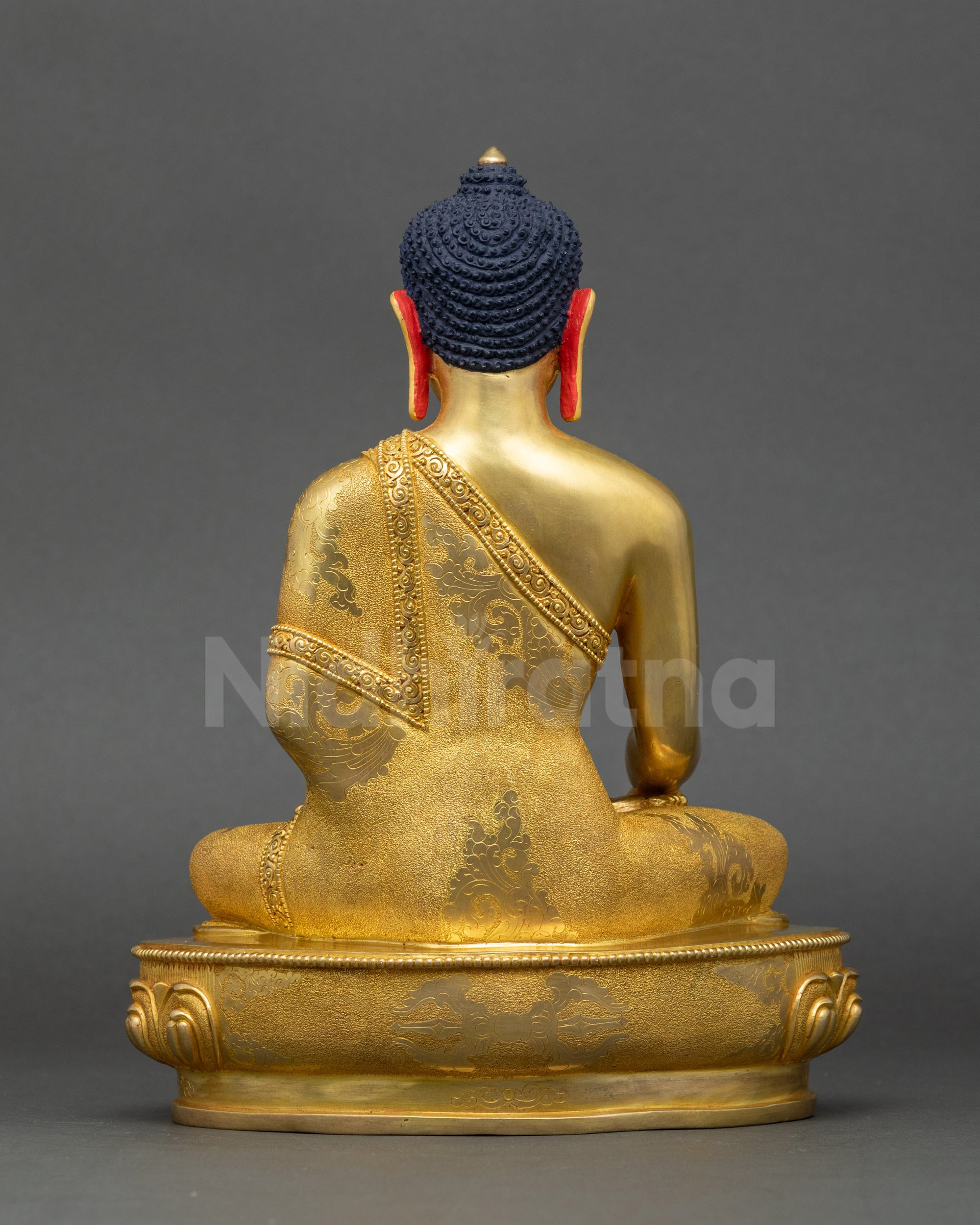 Shakyamuni Buddha statue back view showing detailed robe carving and Newari artistry
