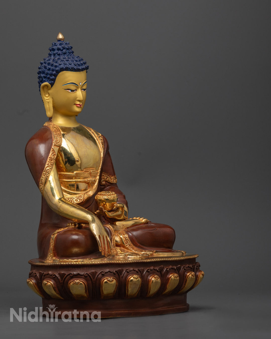 Shakyamuni Buddha statue holding a patra bowl symbolizing compassion and spiritual awakening