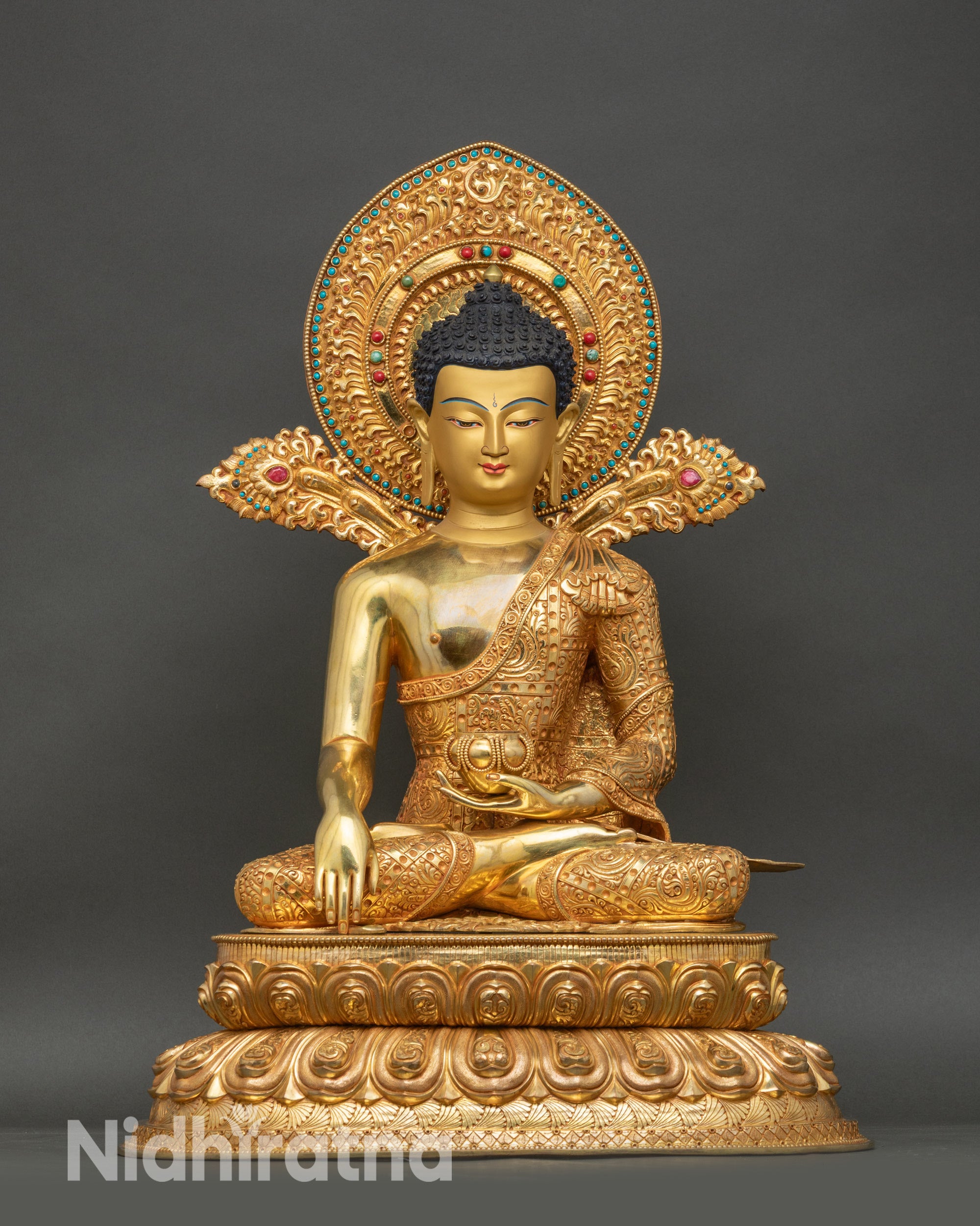 Shakyamuni Buddha statue seated on a layered lotus pedestal, gold fire-gilded copper sculpture