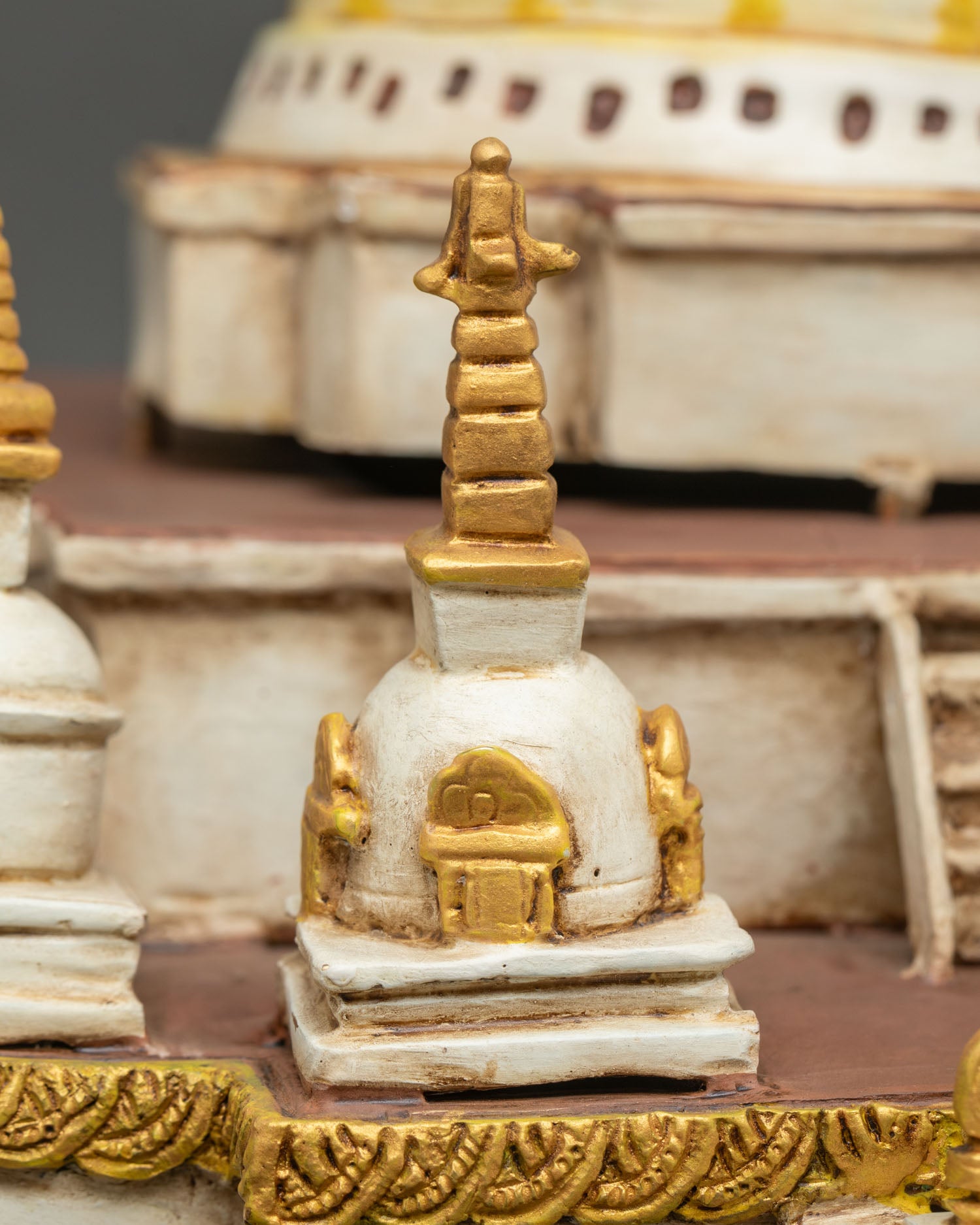 Side base view of Boudha Stupa showing miniature shrines and gold accents