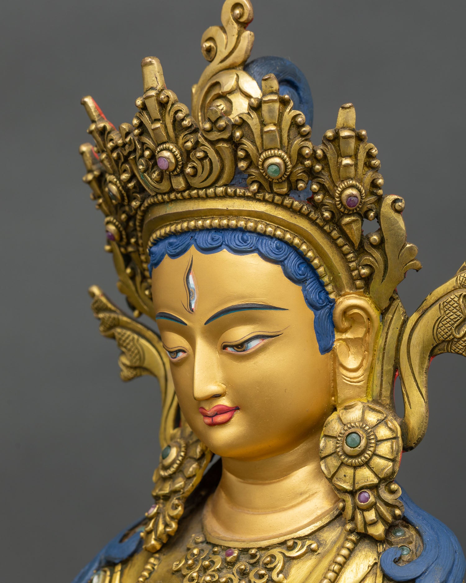 Side face close-up Dukar statue, serene gold face and jeweled crown detail