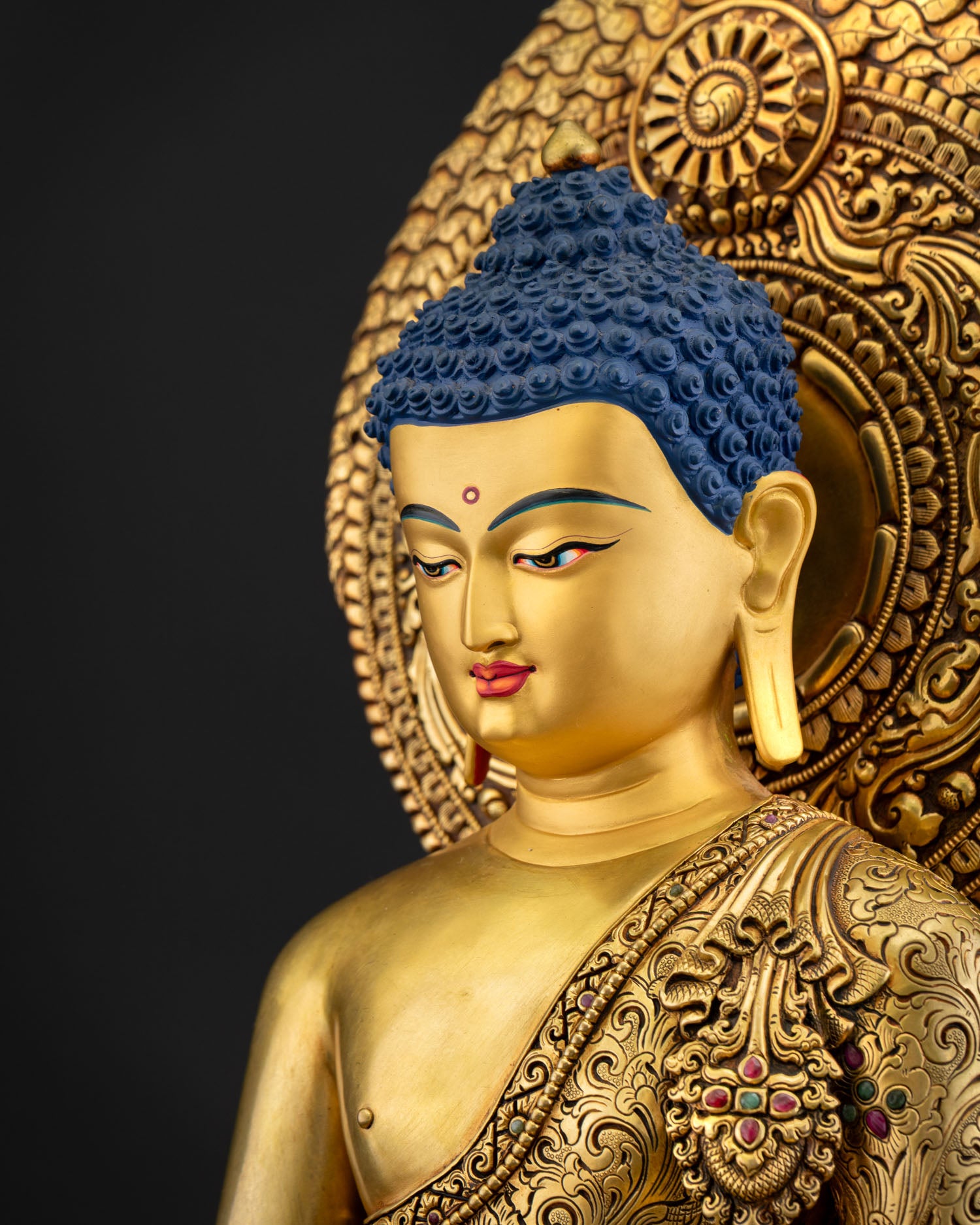 Side close up of Healing Buddha statue highlighting floral motifs, repoussé carving