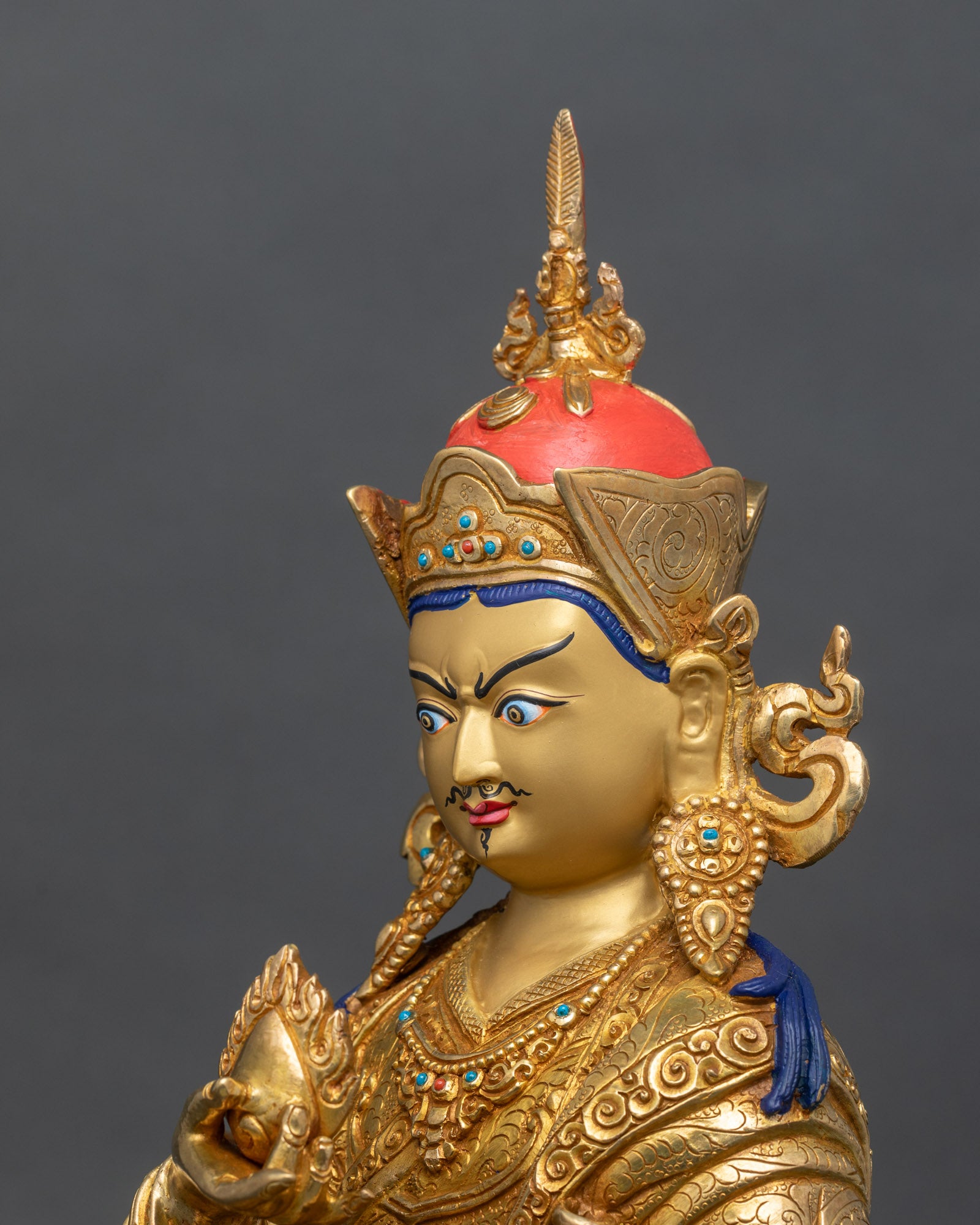 Side detail of Guru Norlha statue with chintamani jewel and jewel spitting mongoose