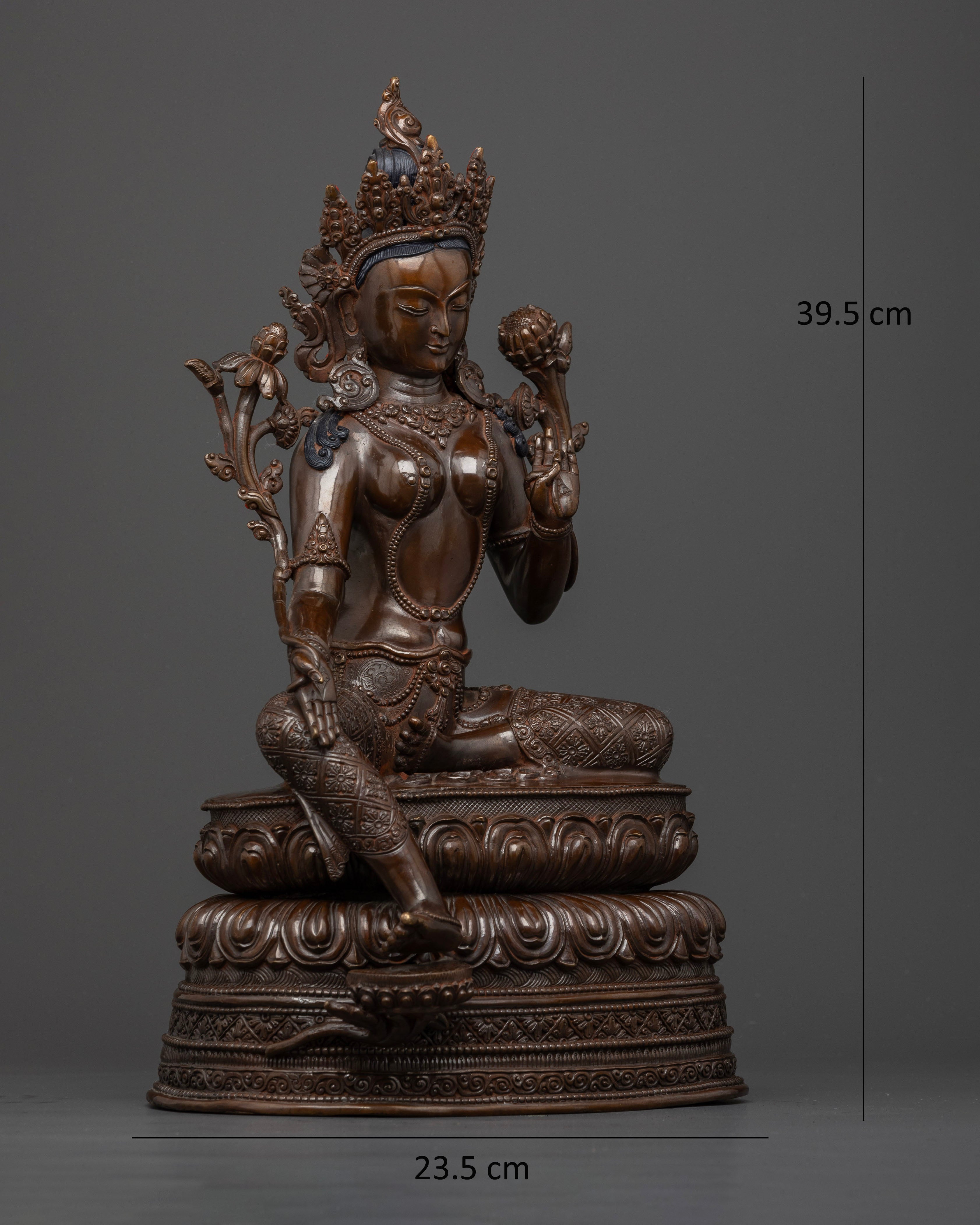 Side view of Dark oxidized Green Tara sculpture seated in royal ease on lotus base copper statue