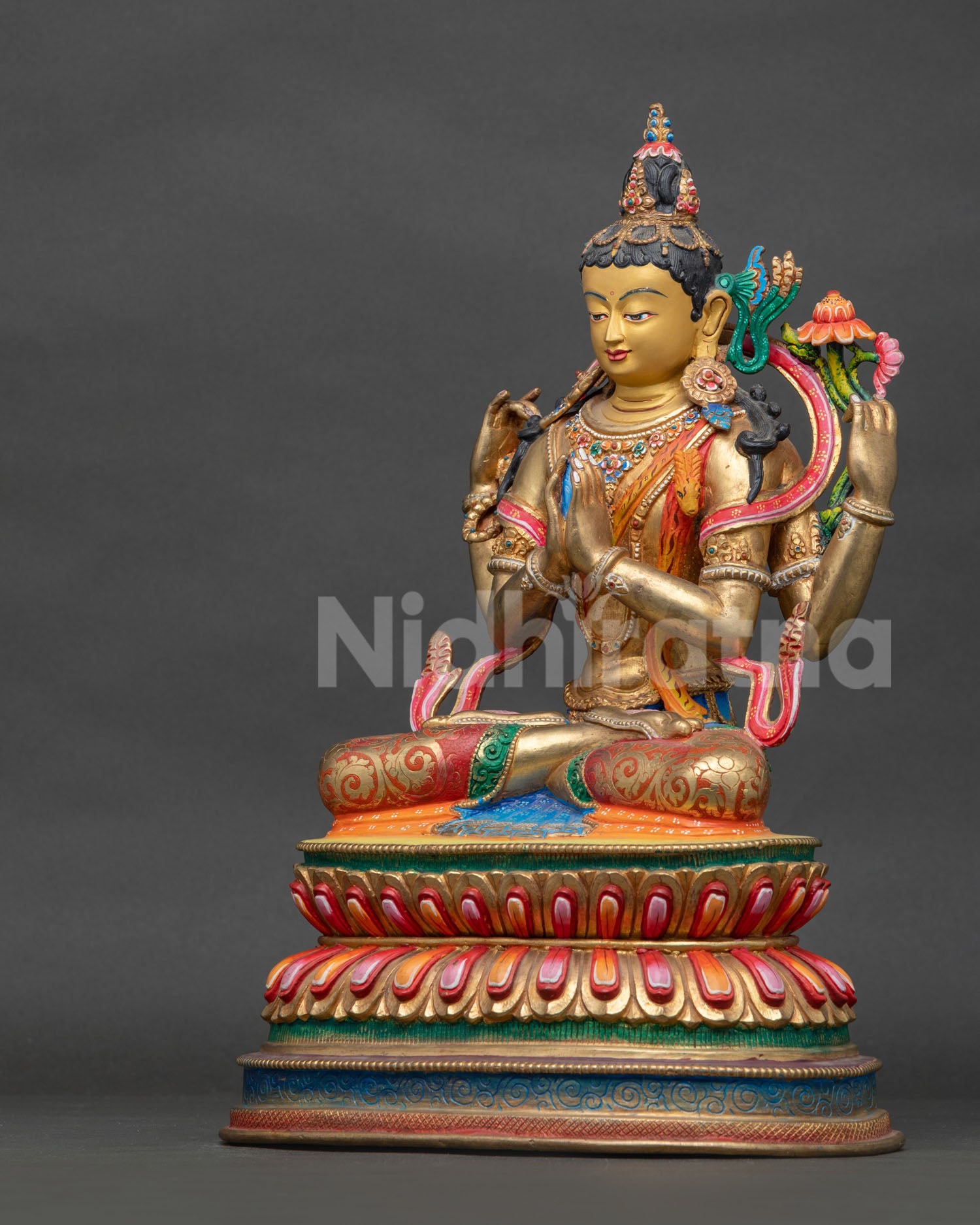 Side view of Chenrezig Statue holding crystal rosary lotus and wish-fulfilling jewel.