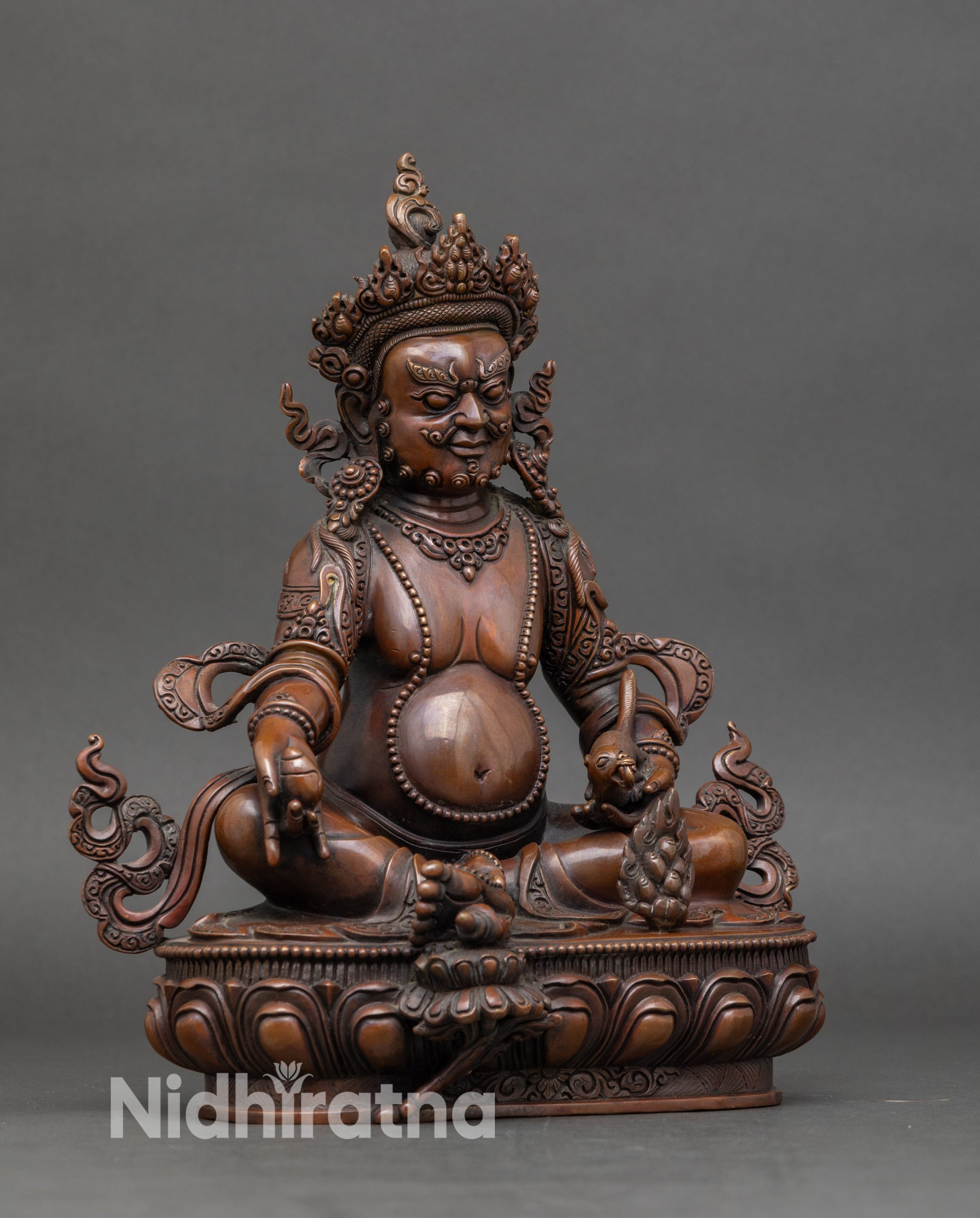 Side view of Nepalese Dzambhala altar figurine with kapala vase and ritual staff, handcrafted by Newari artist