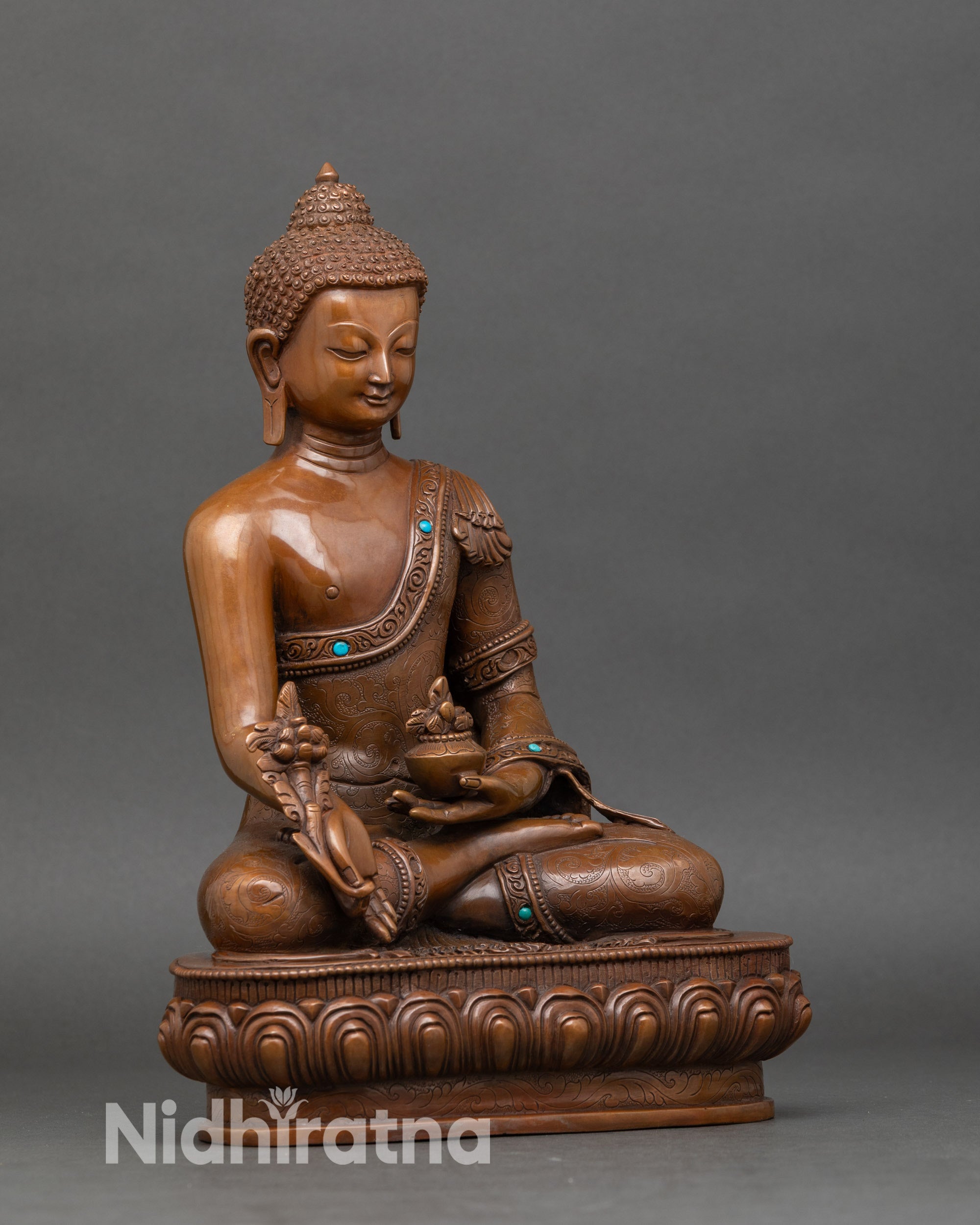 Side view of Nepalese Medicine Buddha statue with right hand in blessing gesture