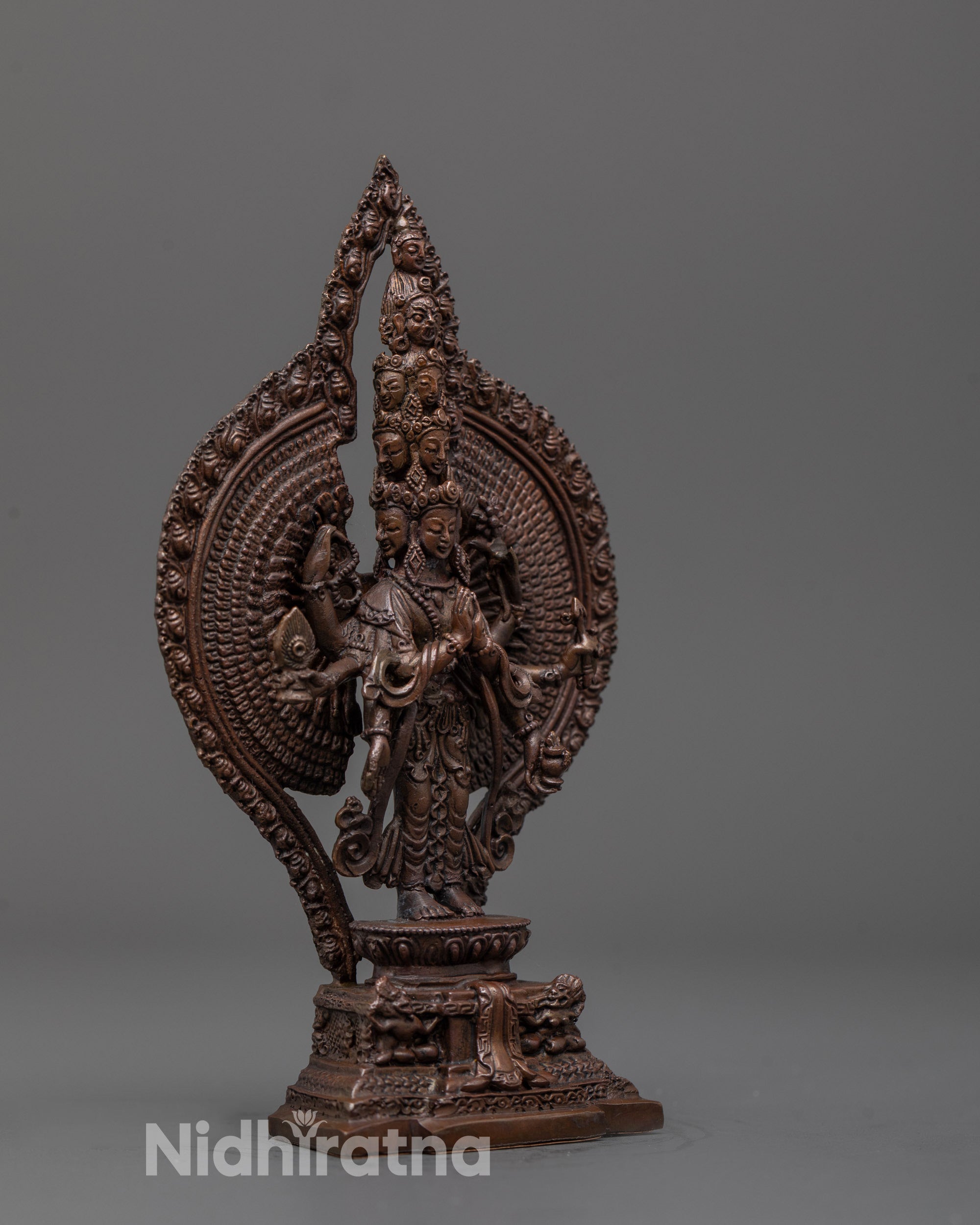 Side angle of 1000-Arm Chenrezig statue highlighting flowing robes and detailed arms
