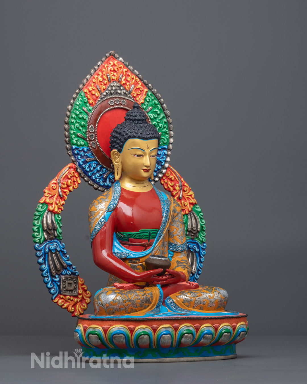 Side angle of Amitabha Buddha sculpture showing intricate robe and multicolored halo