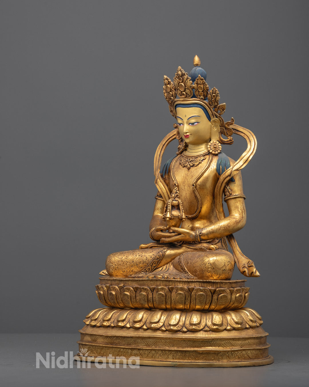 Side angle of Amitayus statue showing swirling scarf and lotus throne details