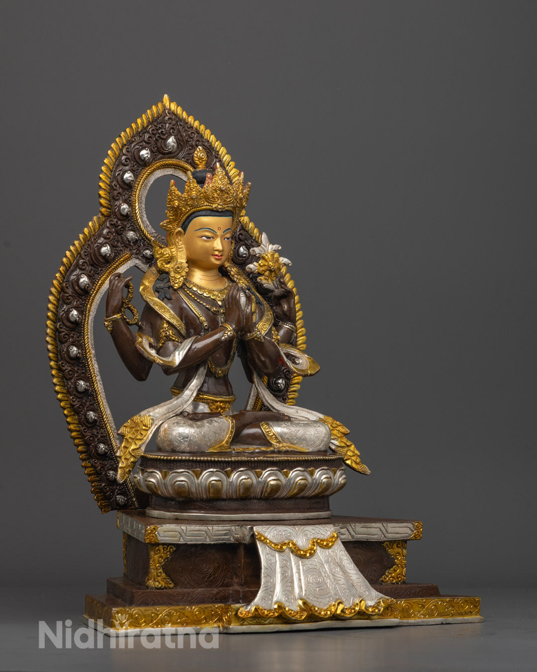 Side angle of Avalokiteshvara statue showcasing prayer beads, lotus flower