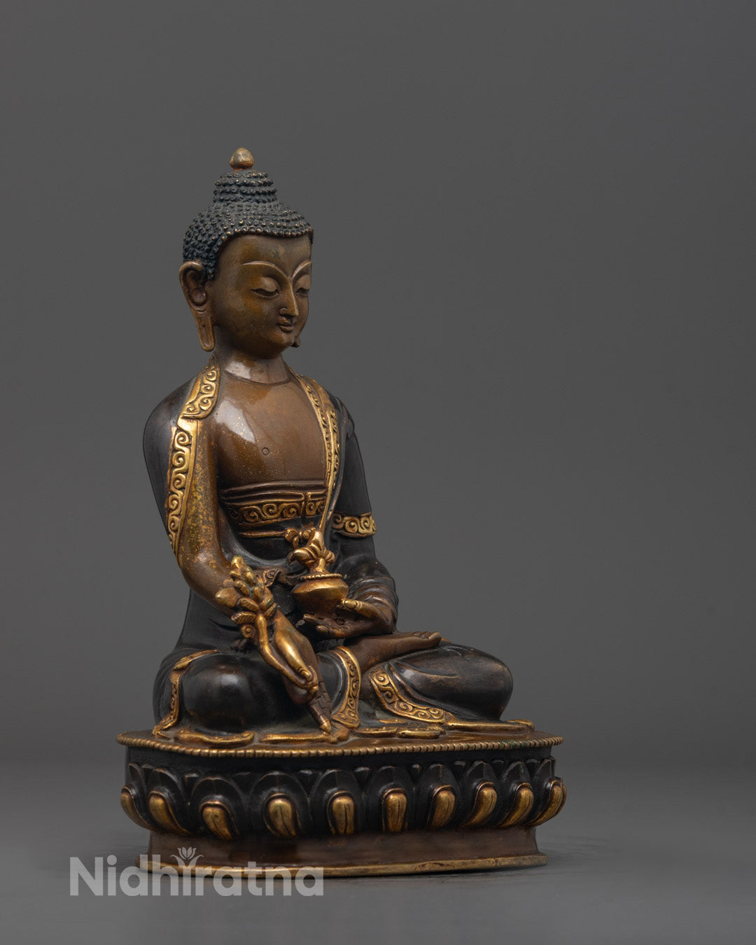 Side angle of Bhaisajyaguru Statue showing monk’s bowl and intricate robe carvings