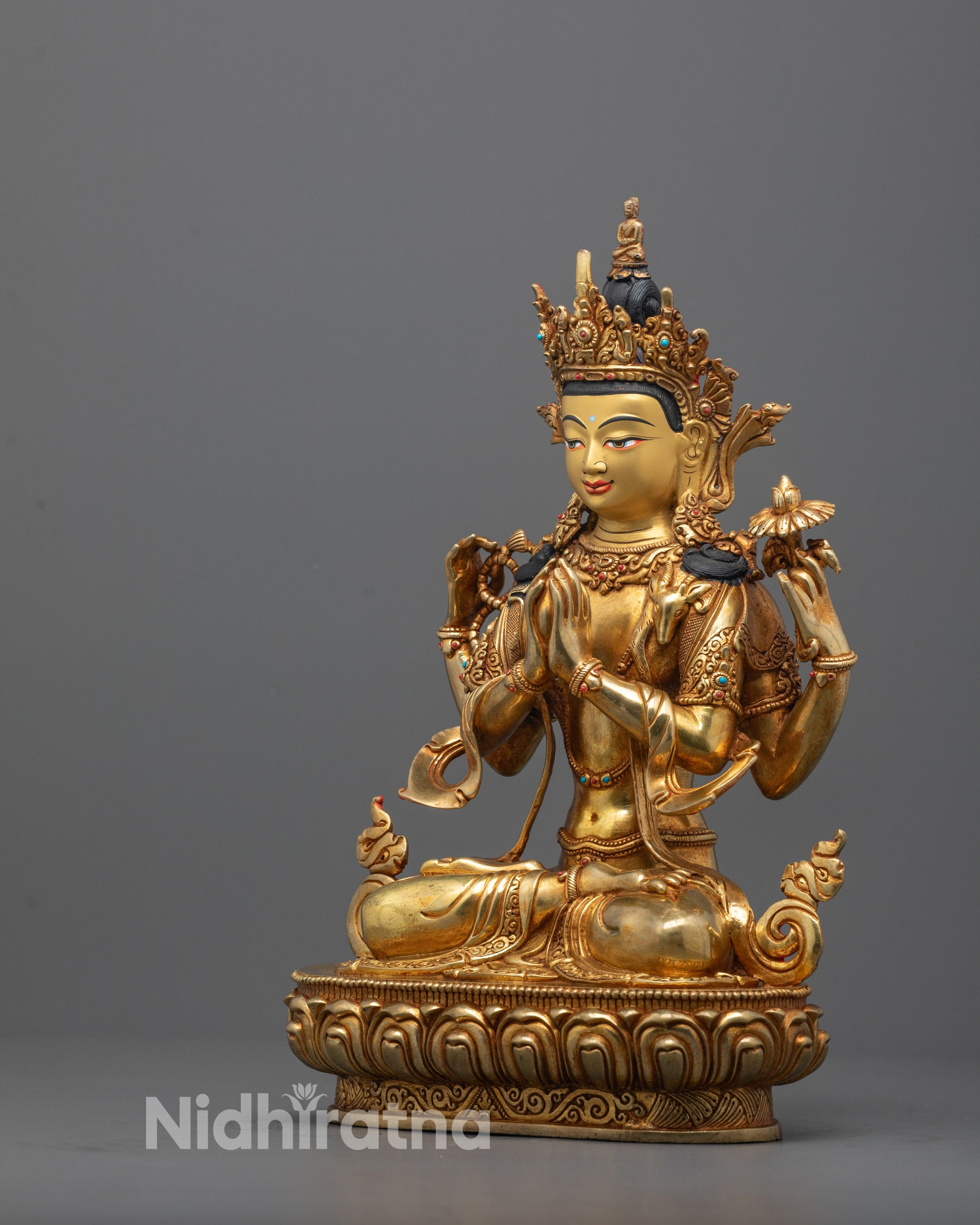 Side angle of Buddhist Chenrezig statue showing lotus, rosary, and wish-fulfilling jewel