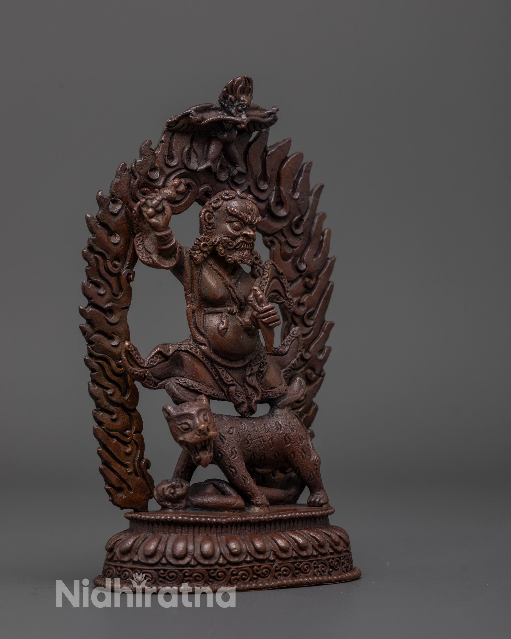 Side angle of Dorje Drolo Statue showing flowing robes and oxidized copper finish detail