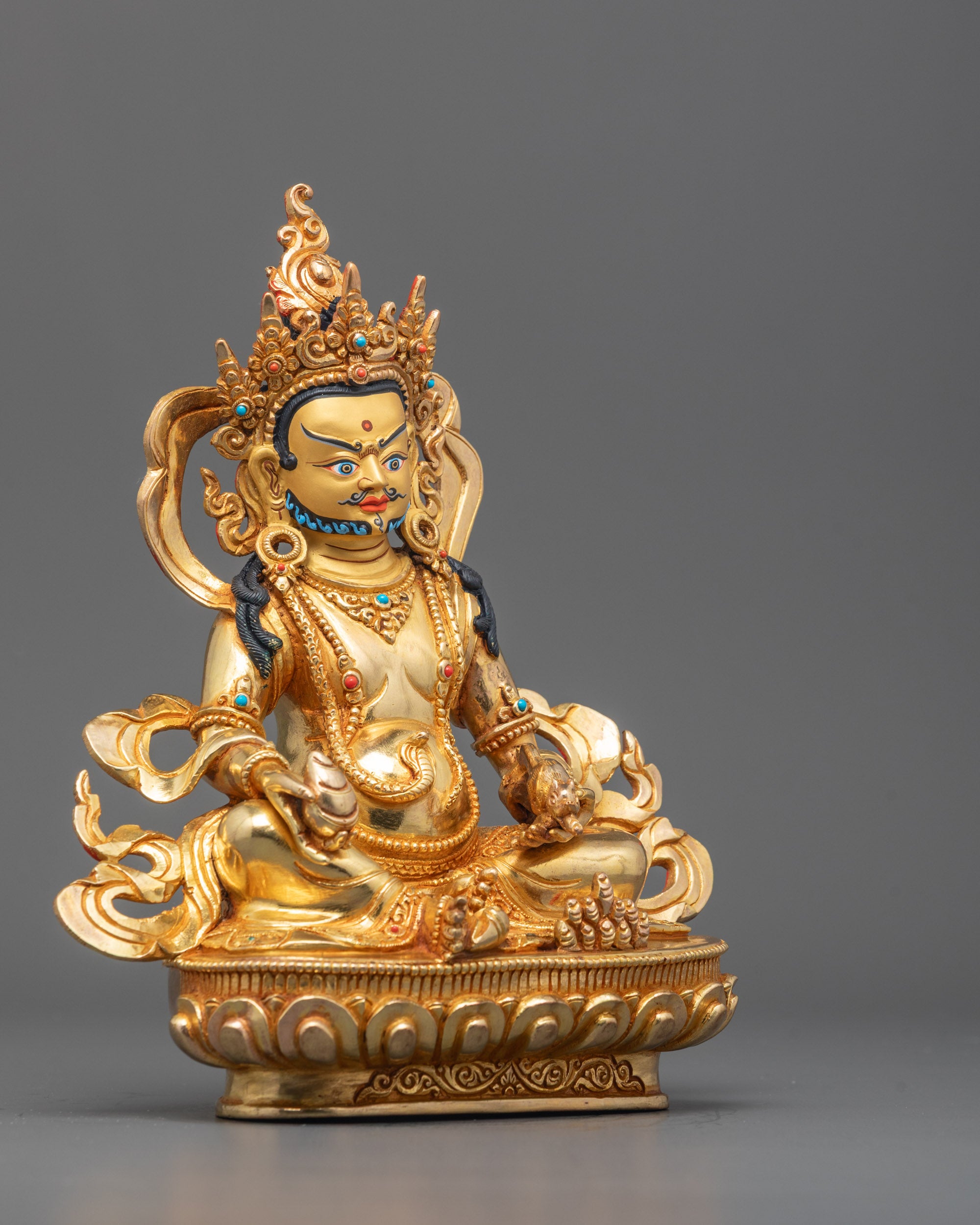 Side angle of Dzambhala Statue showing detailed carvings, citron fruit, and lotus throne