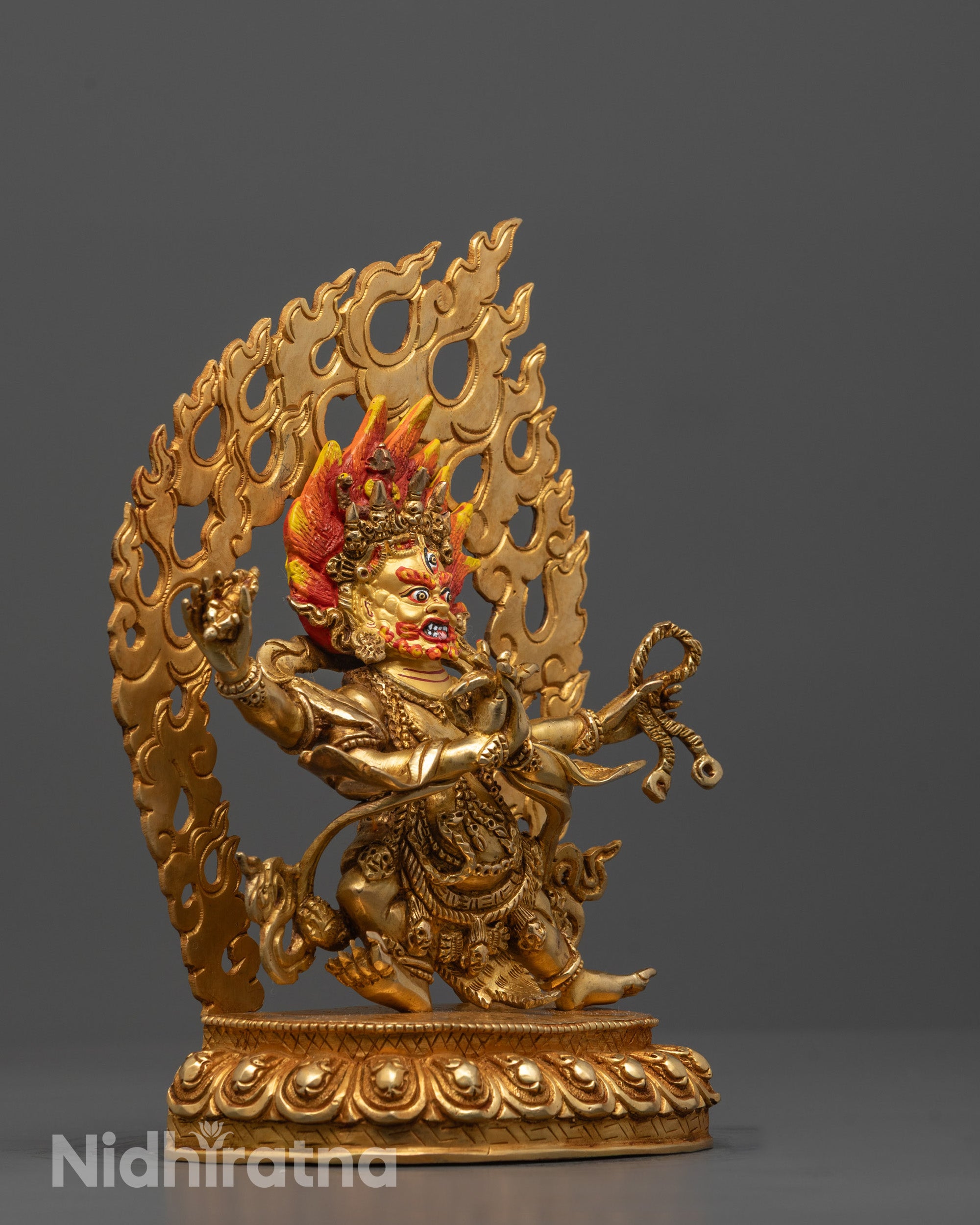 Side angle of Four Armed Vajrapani statue showing four hands holding symbolic ritual objects