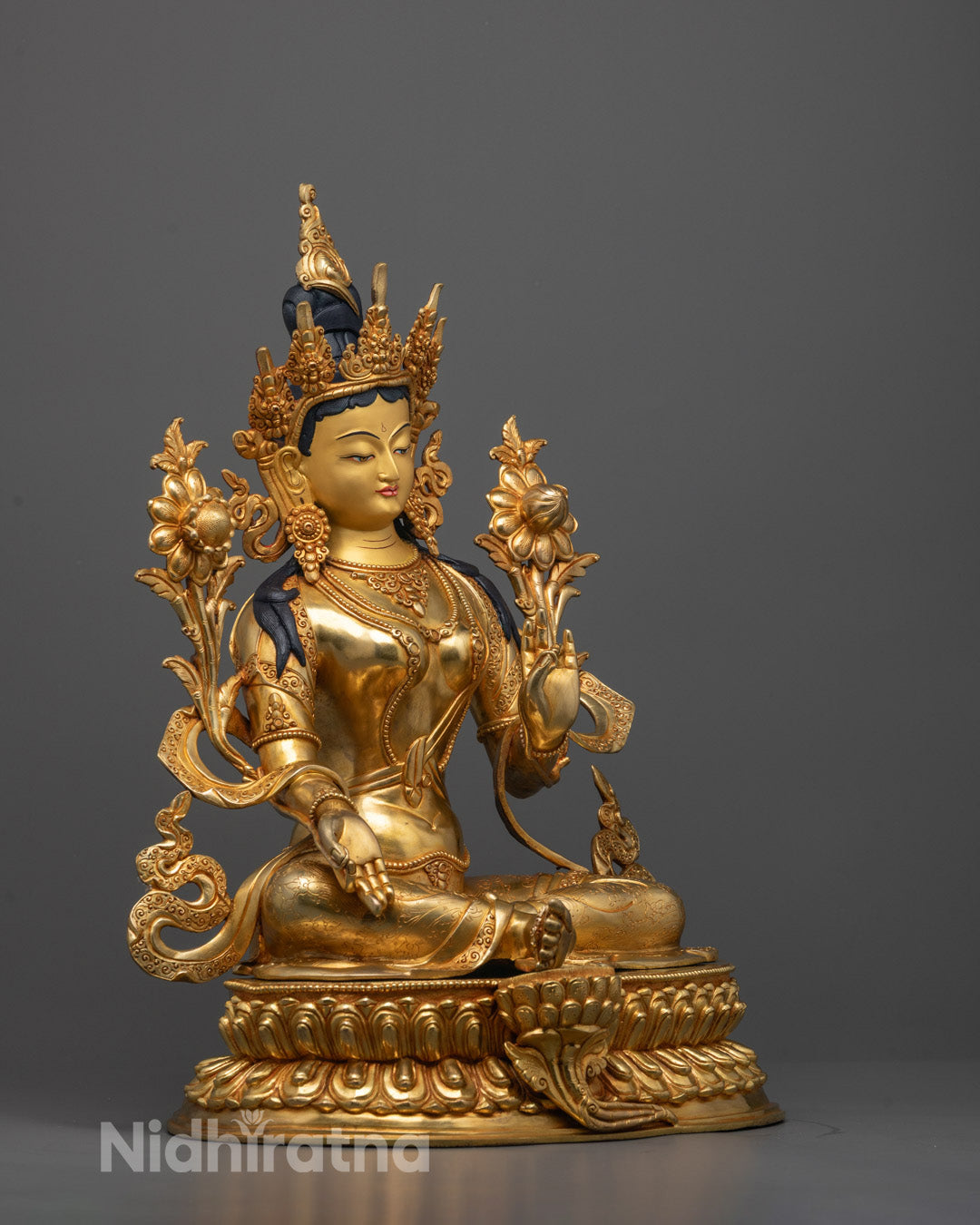 Side angle of Green Tara Statue highlighting extended leg posture