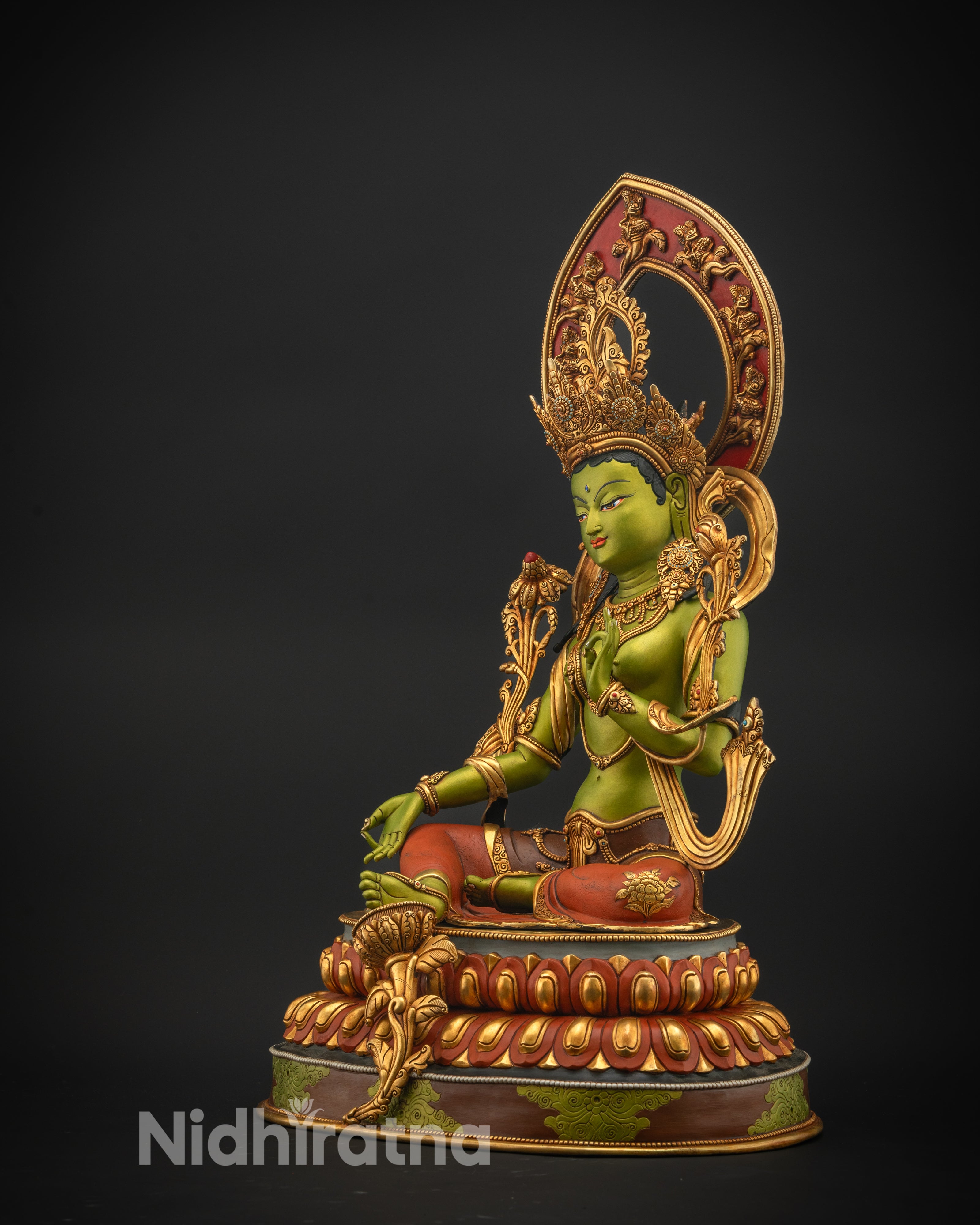 Side angle of Green Tara Statue showing flowing robes, lotus seat, and detailed carving