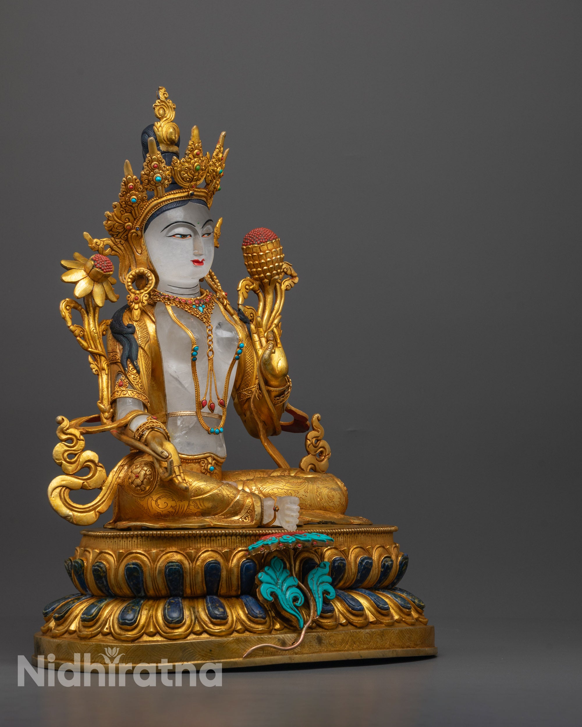 Side angle of Green Tara Statue showing royal ease pose and coral-adorned pedestal
