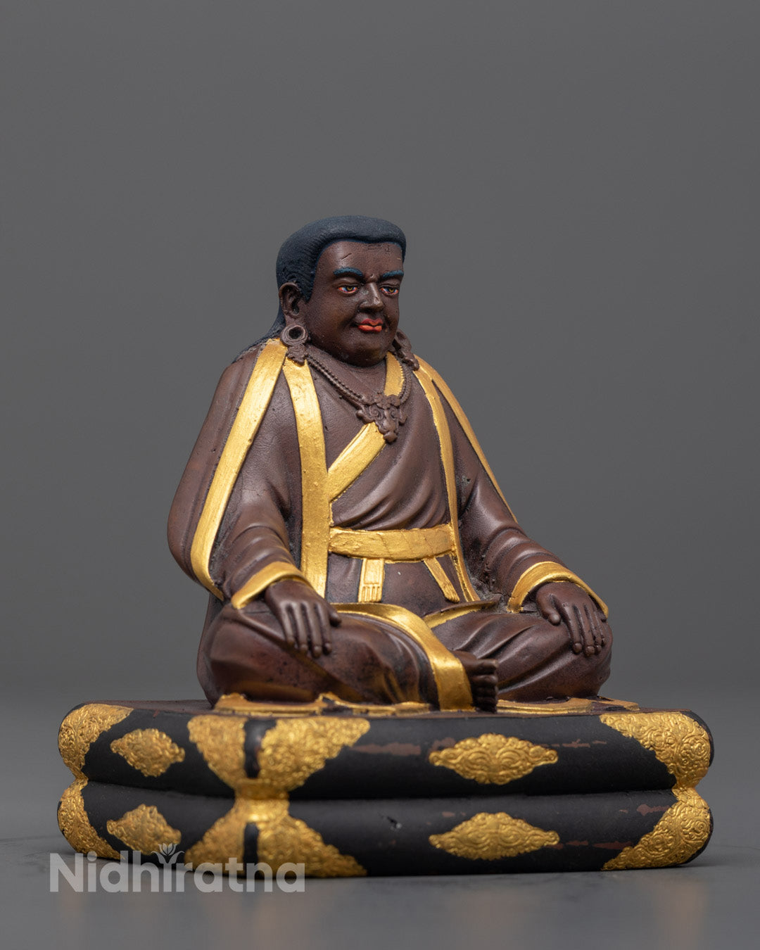 Side angle of the Marpha statue showing detailed robe, jewelry, and vibrant acrylic paint