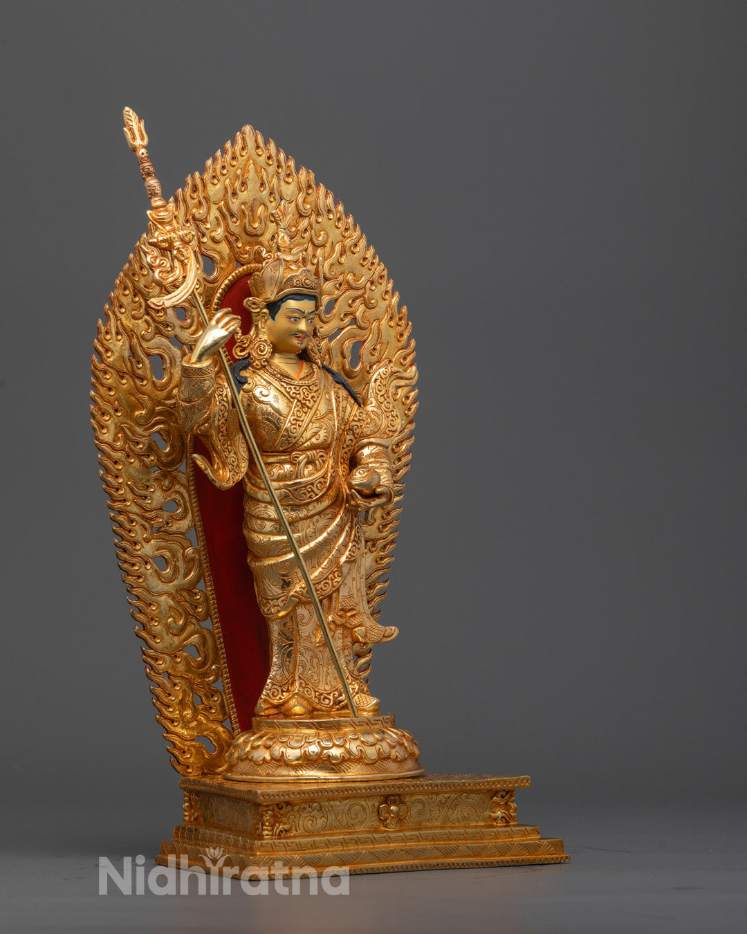 Side angle of Standing Guru Rinpoche statue showing flowing robes and trident khatvanga