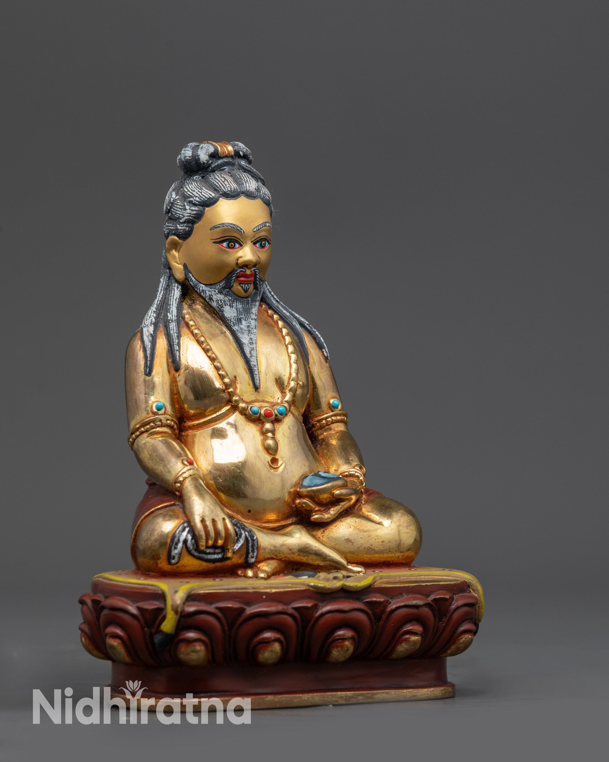 Side angle of Thangtong Gyalpo Sculpture with chain, kapala, and turquoise inlays