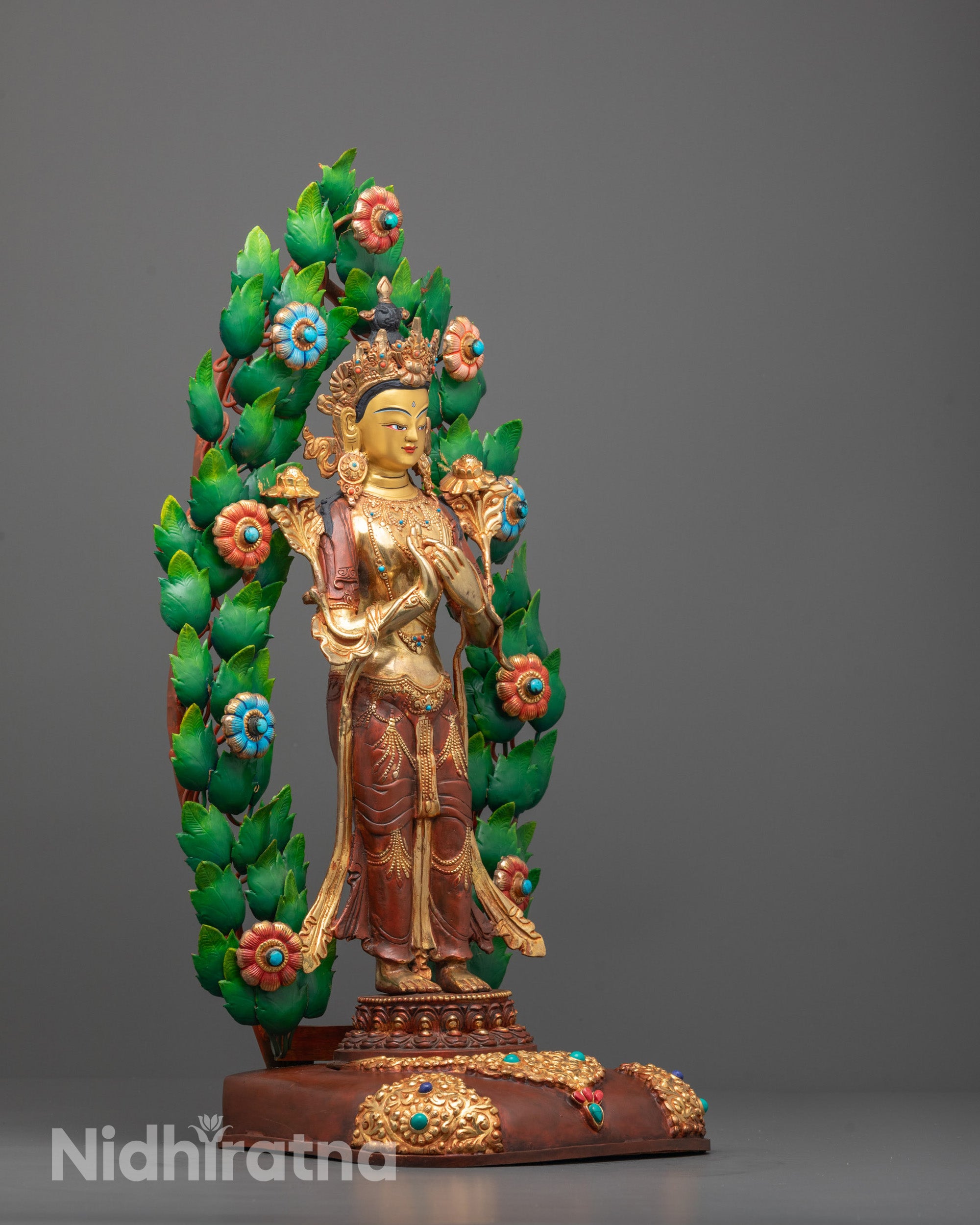 Side angle of Tibetan Maitreya Buddha statue showing utpala flowers and jeweled adornments