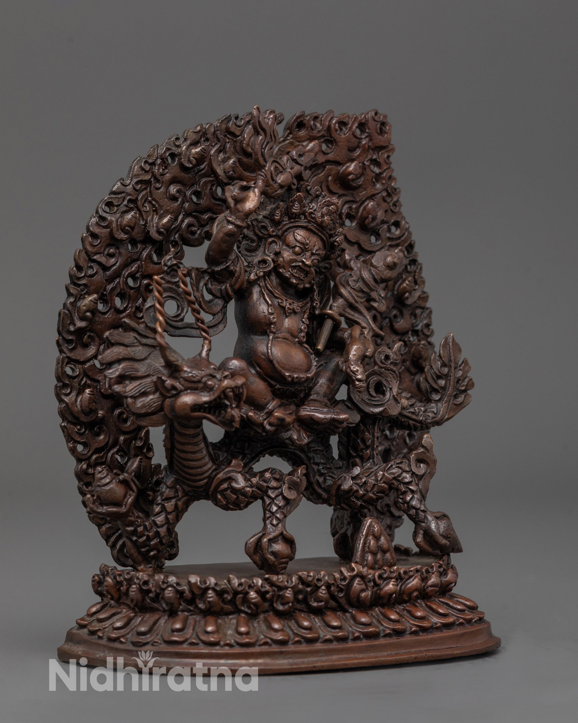 Side angle of White Dzambhala Statue showing intricate robe and dragon details