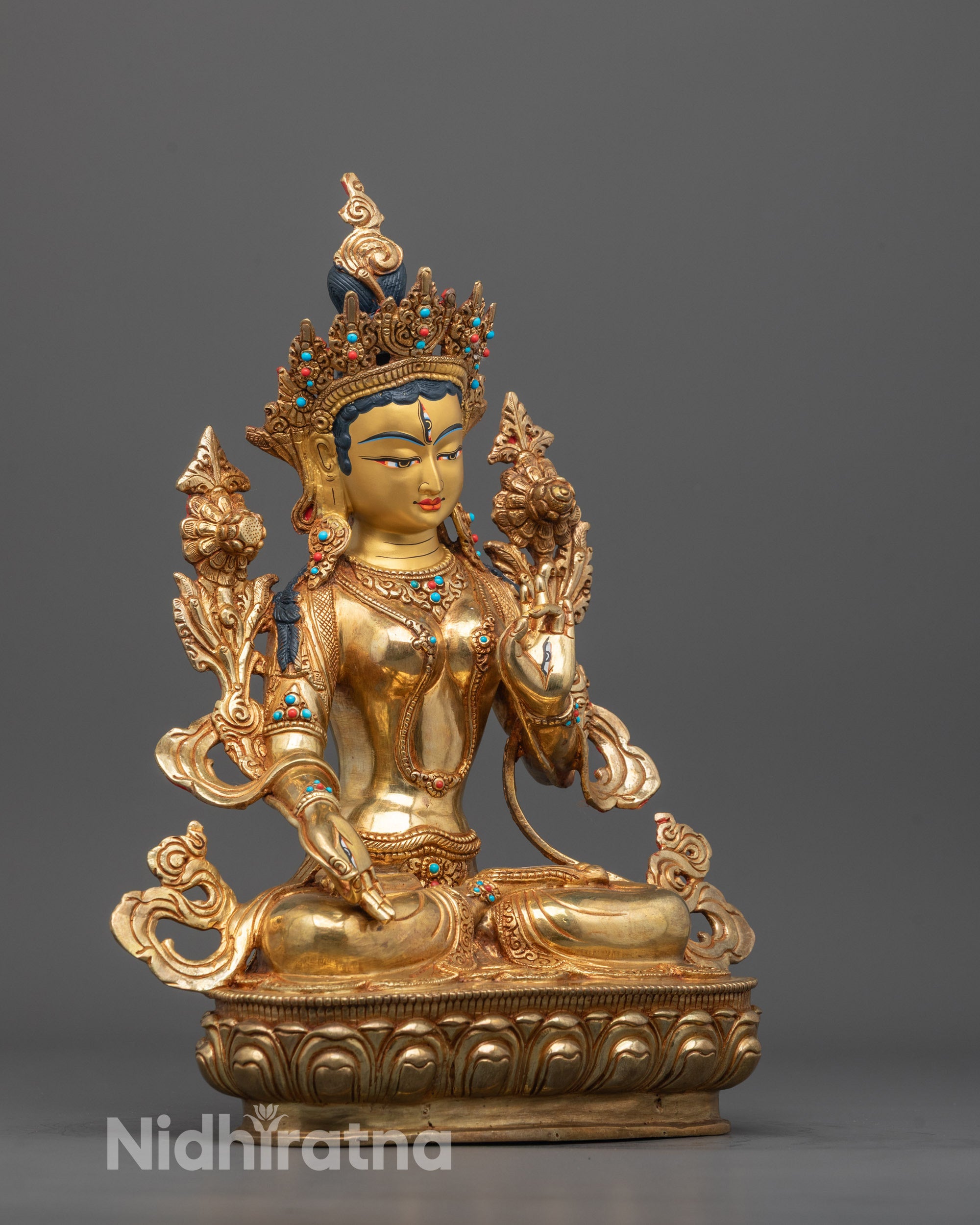 Side angle of White Tara statue showing radiant halo and intricate hand-carved details