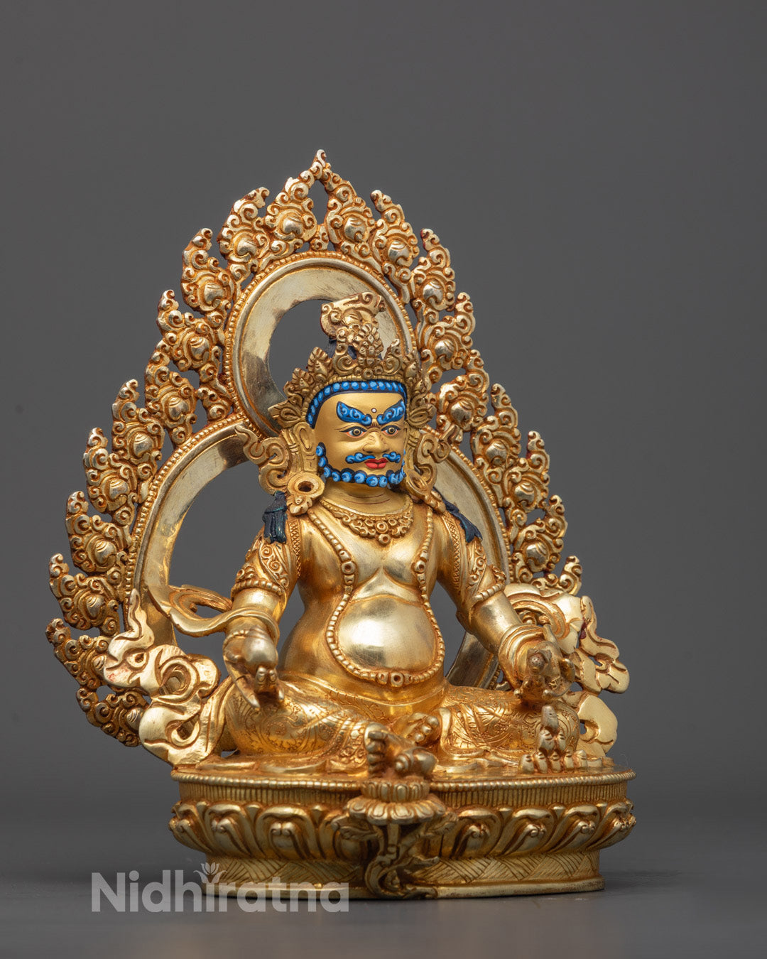 Side angle of handcrafted Dzambhala sculpture showing bijapuraka fruit detail