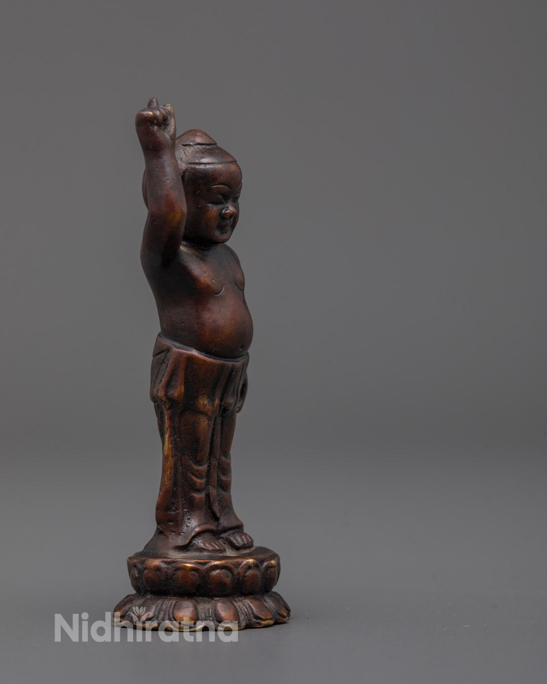 Side angle of handcrafted Little Buddha Idol showing lotus throne and oxidized copper details
