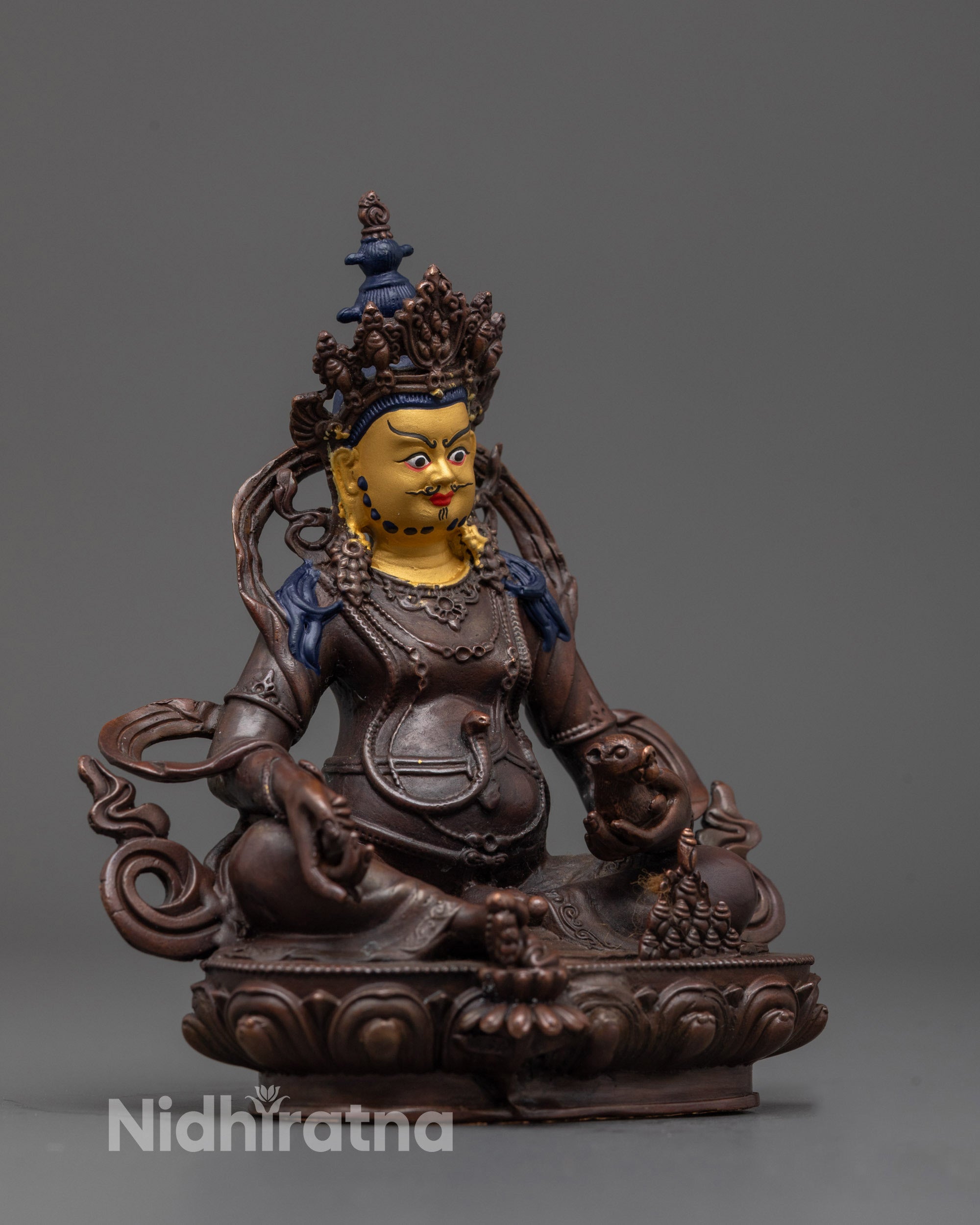 Side angle of machine-crafted Dzambhala statue with aged oxidized finish and gold face