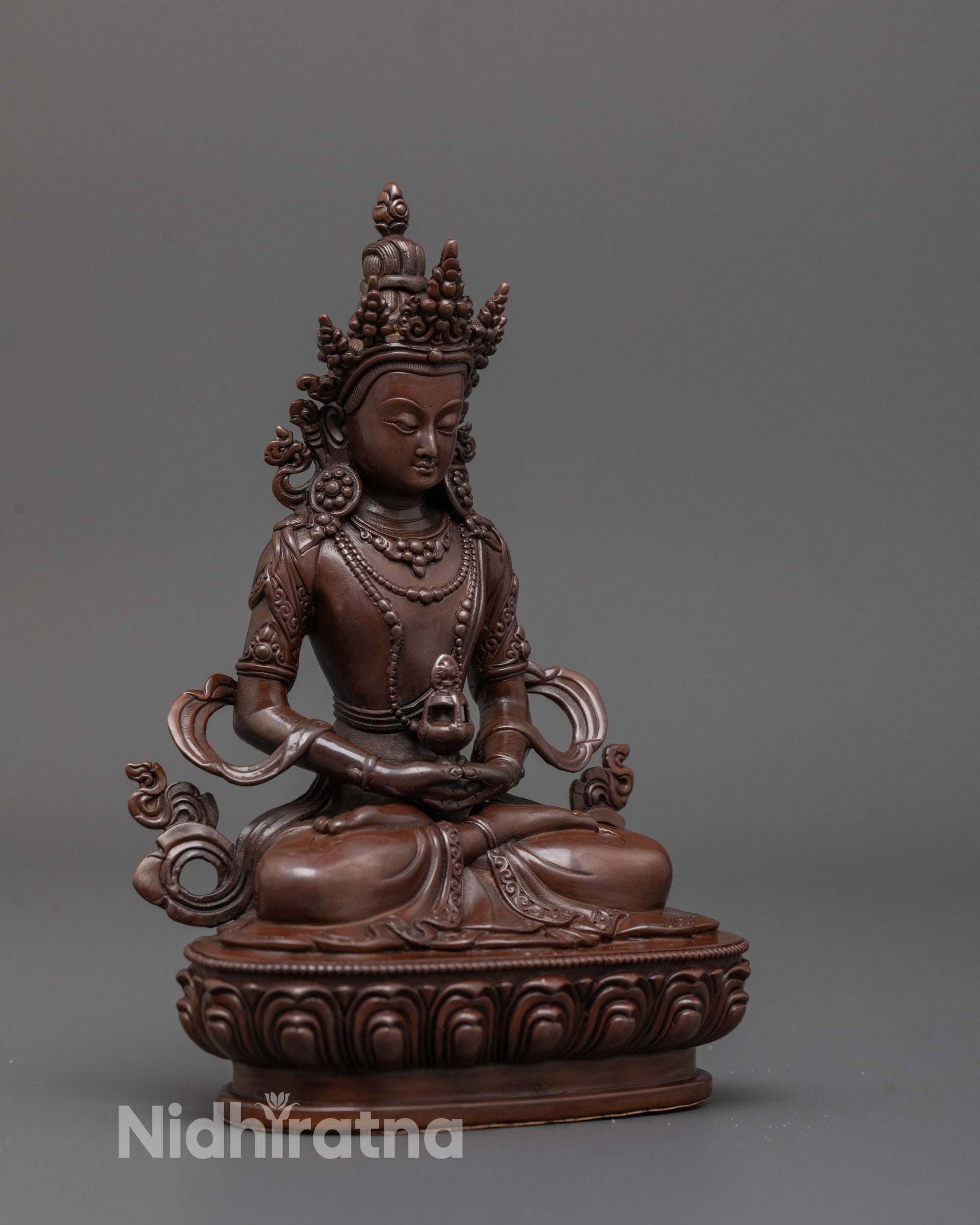 Side angle of machine-made Amitayus Statue showing detailed robes and oxidized finish