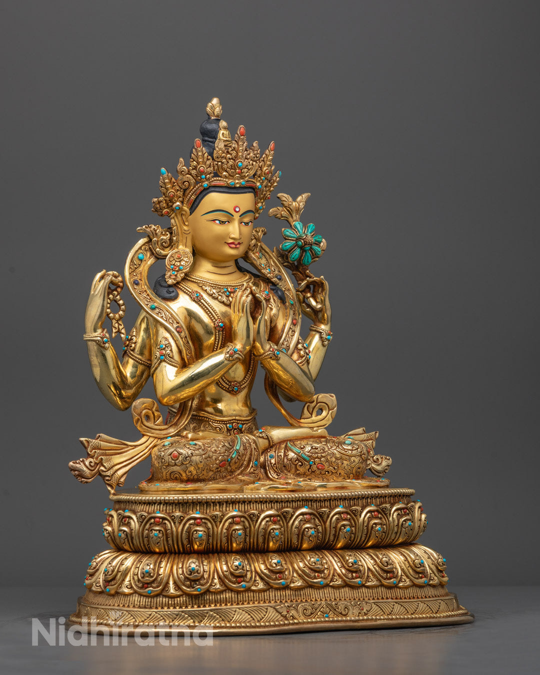 Side angle of sacred Chenrezig statue showing detailed halo, crown, and flowing robe carvings