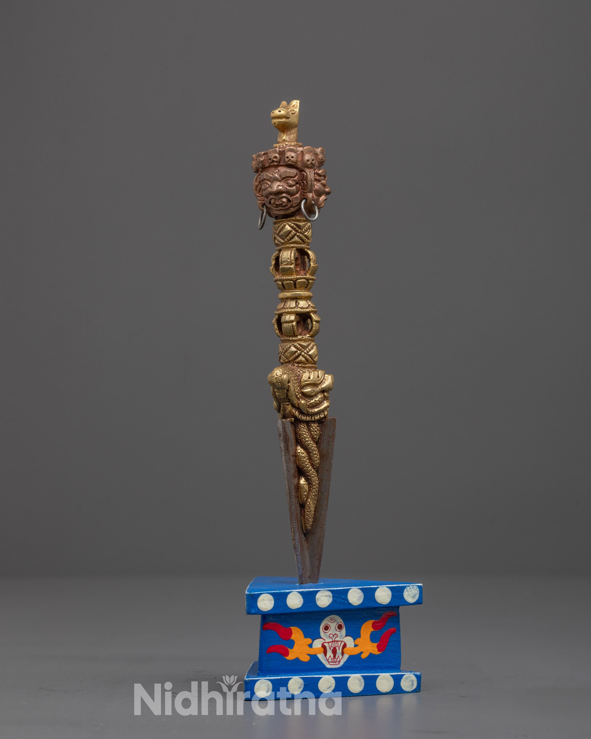 Side angle of sacred Phurba dagger made from copper and iron, used for spiritual protection