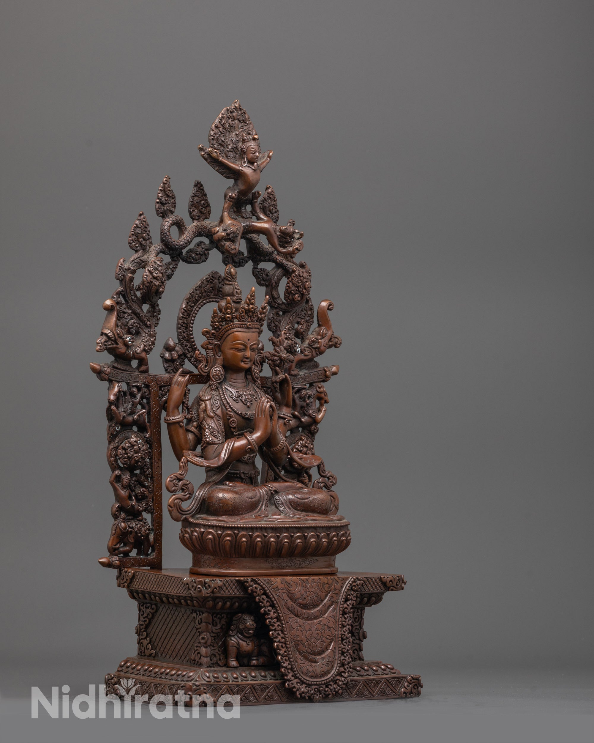 Side angle of the oxidized Chenrezig Statue revealing detailed robe patterns