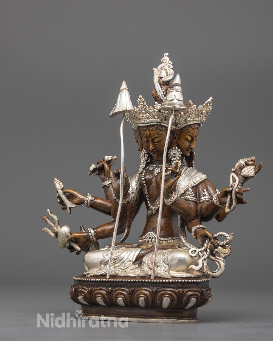 Side angle showing 3-armed Dukkar holding vajra, sword, and bow with ornate crown details
