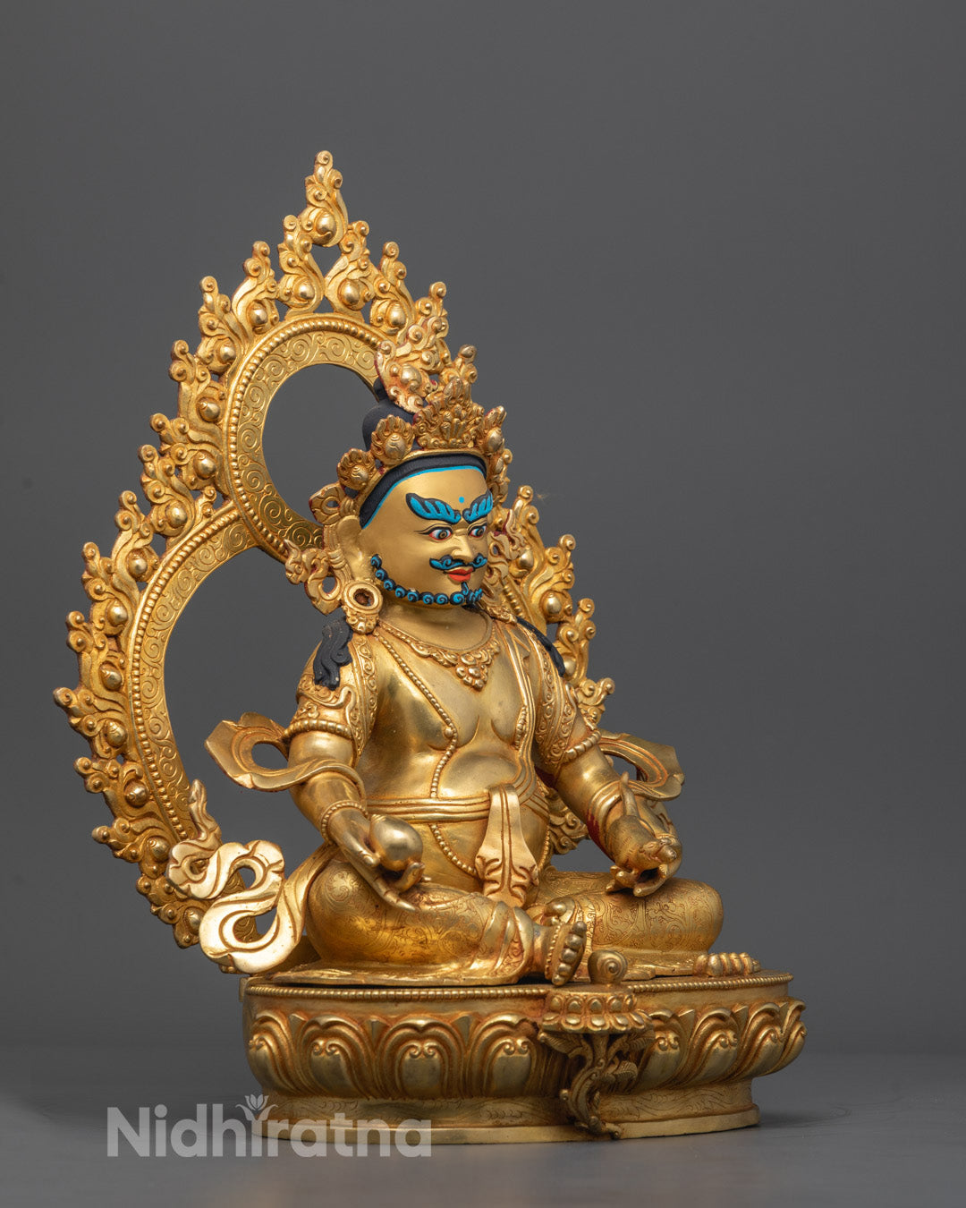 Side angle showing Dzambhala holding citron fruit in Varada Mudra and jewel-spitting mongoose.