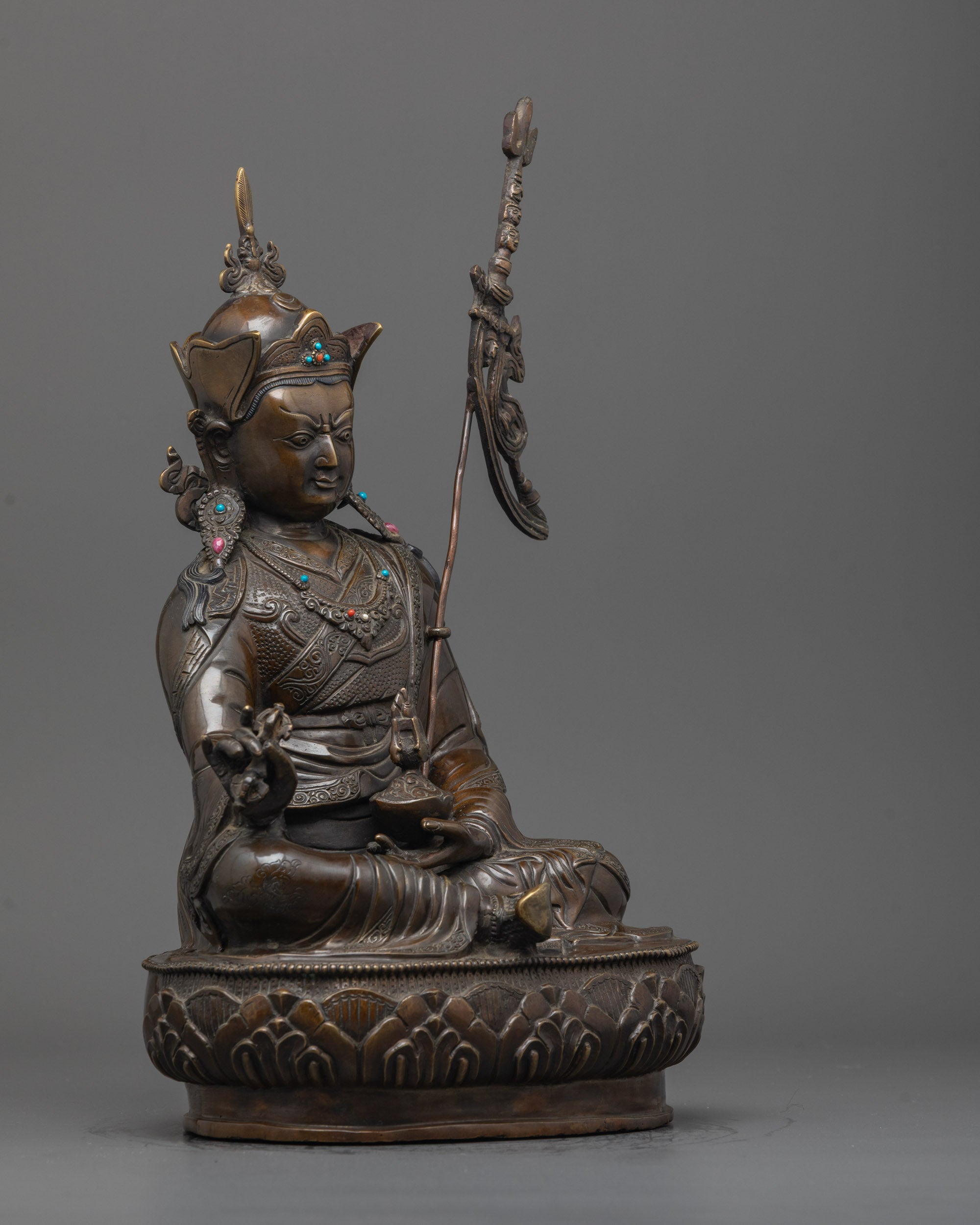 Side angle showing Guru Rinpoche Statue’s trident, skull cup, and detailed jewelry