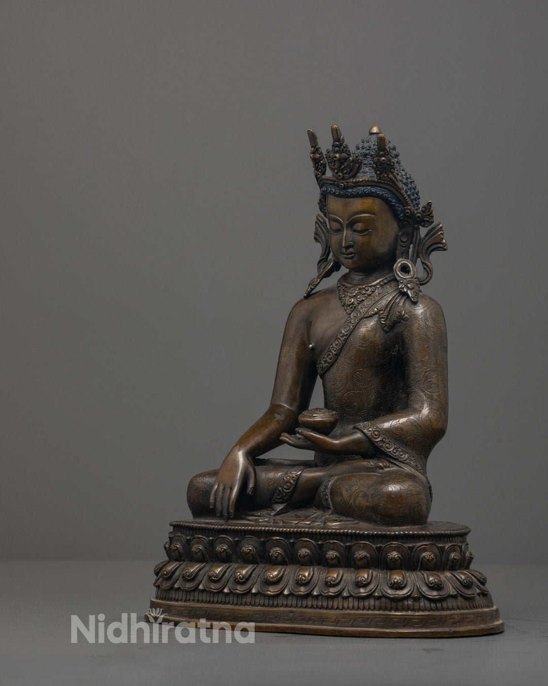 Side angle showing finely carved monk’s robe on handcrafted Crowned Shakyamuni Buddha