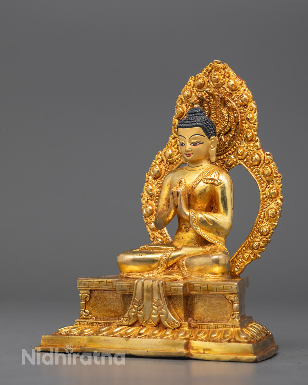 Side angle showing intricate carvings on Vairocana Buddha’s robe, halo, and lotus throne detail.