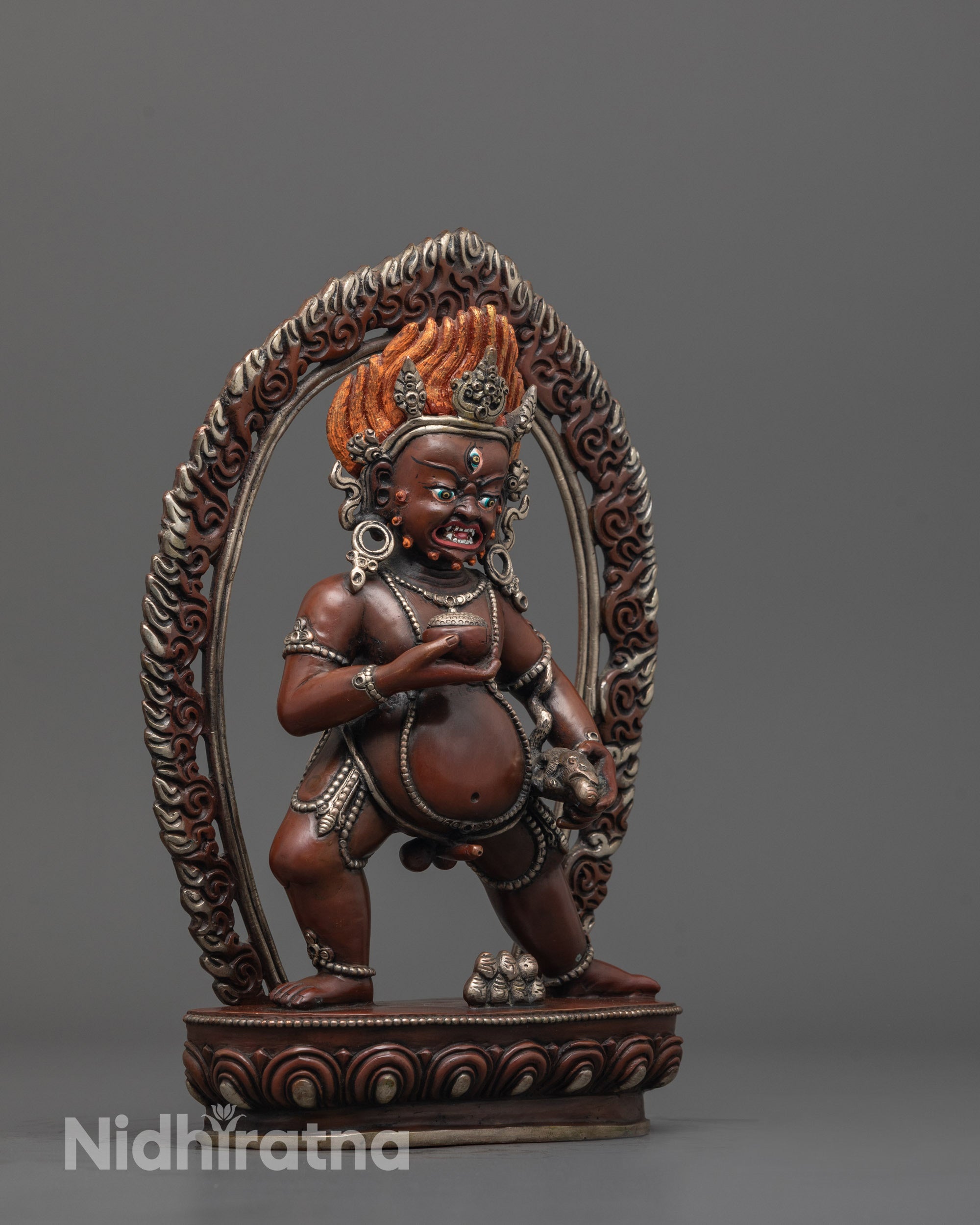 Side angle showing silver-plated lotus base and details of Nepalese Dzambhala wealth god