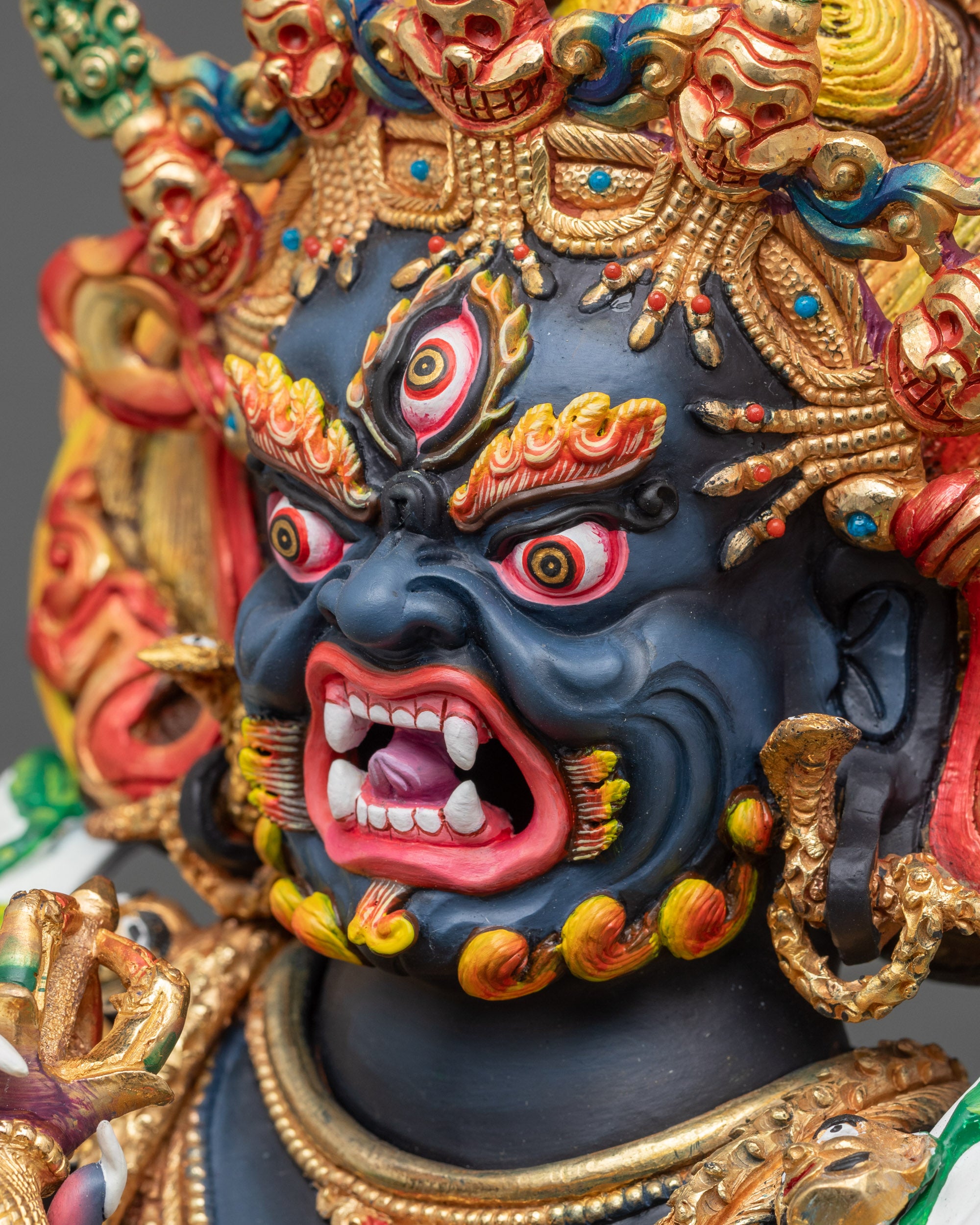 Side close-up of Mahakala face showing wrathful expression and hand-painted acrylic details