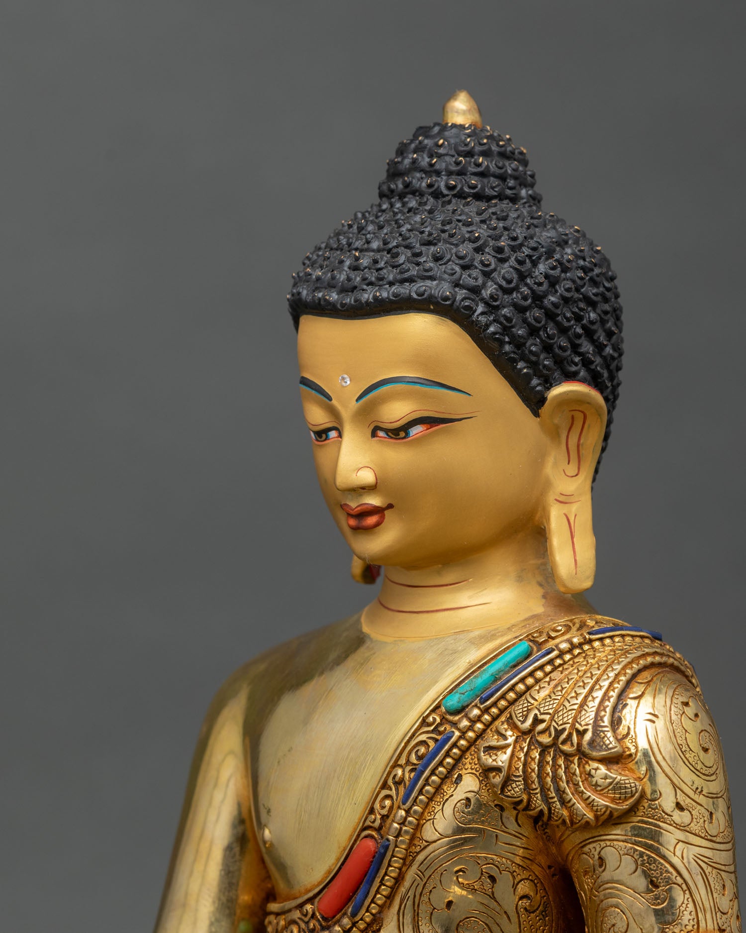 side-close-up-of-medicine-buddha-statue-highlighting-engraved-robes-and-healing-bowl