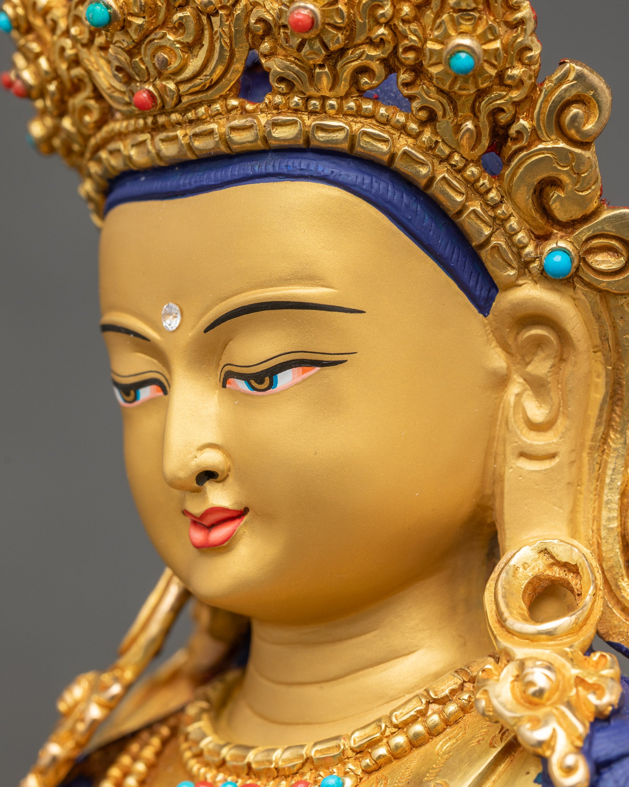 Side close-up of Simhada Chenrezig face with intricate crown and serene expression