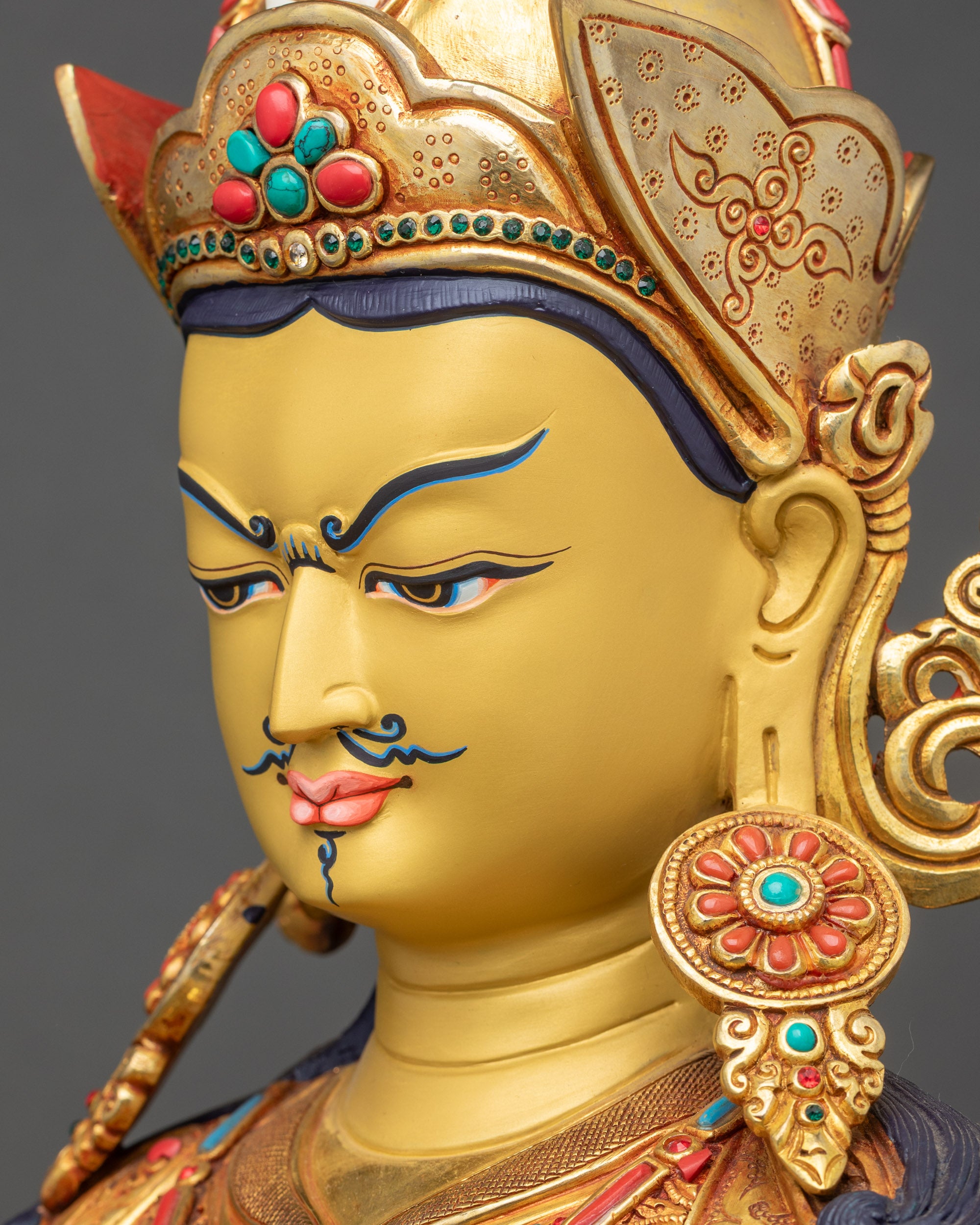 Side close-up of Tsokye Dorje Statue face with expressive eyes and intricate carvings