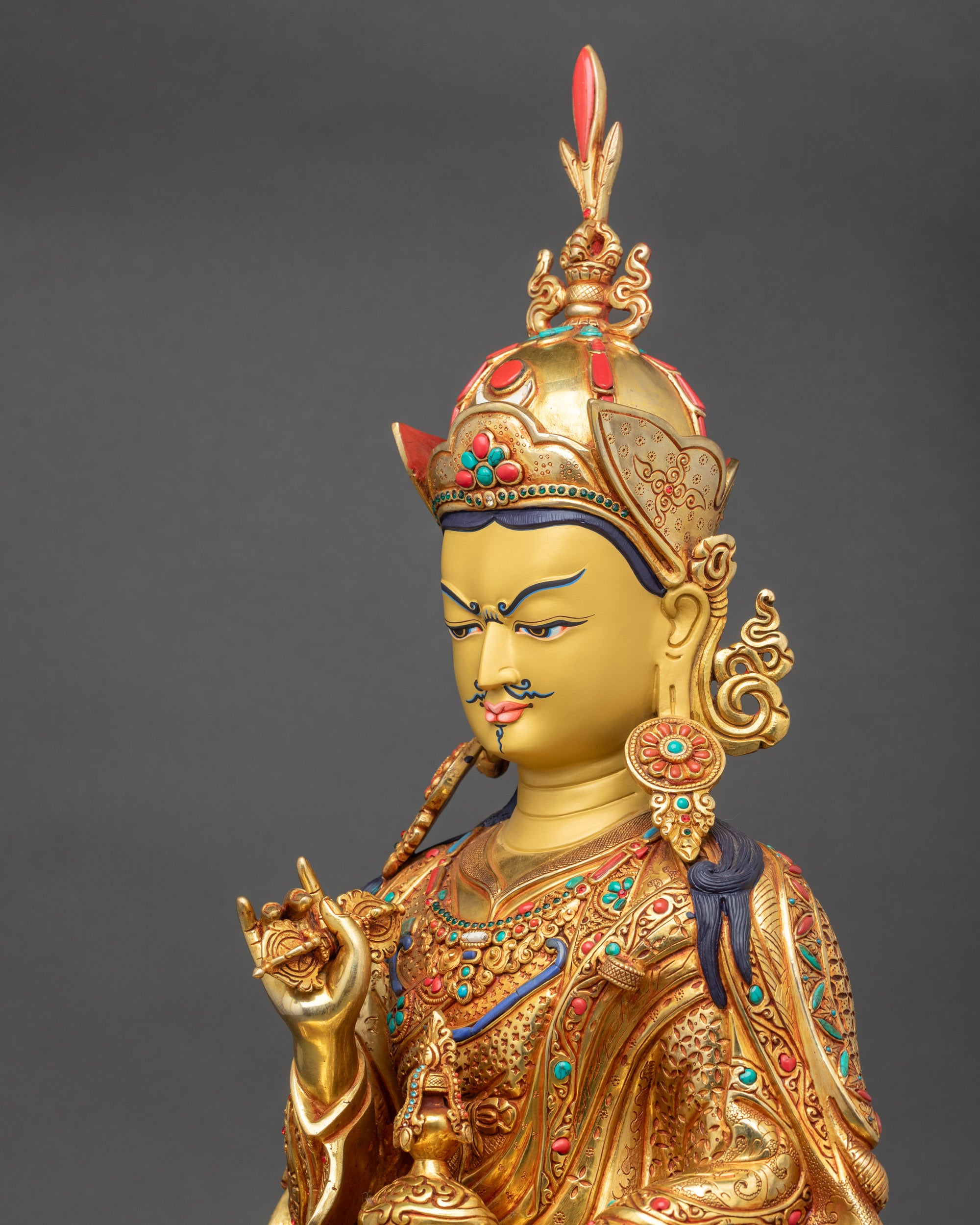 Side close-up of Tsokye Dorje Statue showing lotus hat, vulture feather, and ritual implements